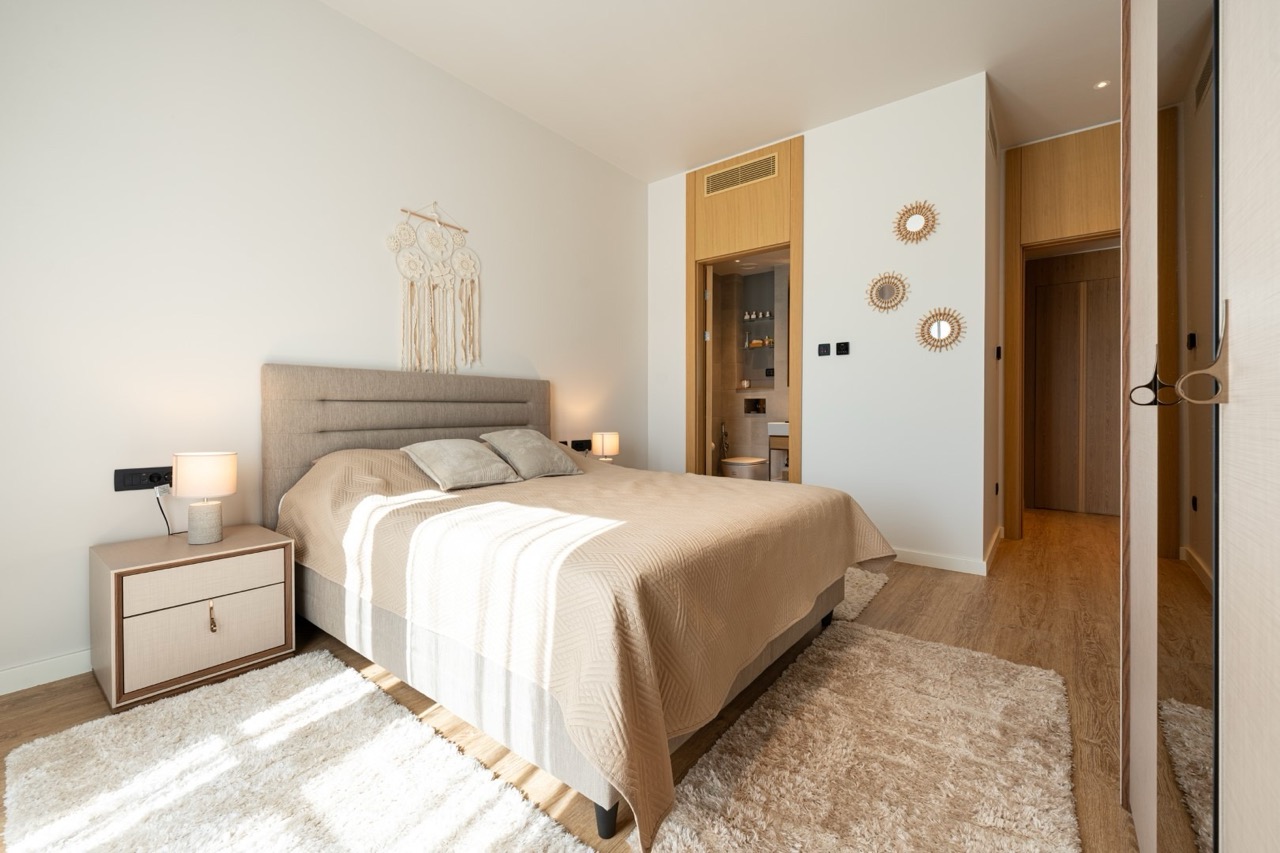 Modern bedroom with a double bed in an apartment, Porto Montenegro, Tivat, Montenegro: stylish interior and decor.