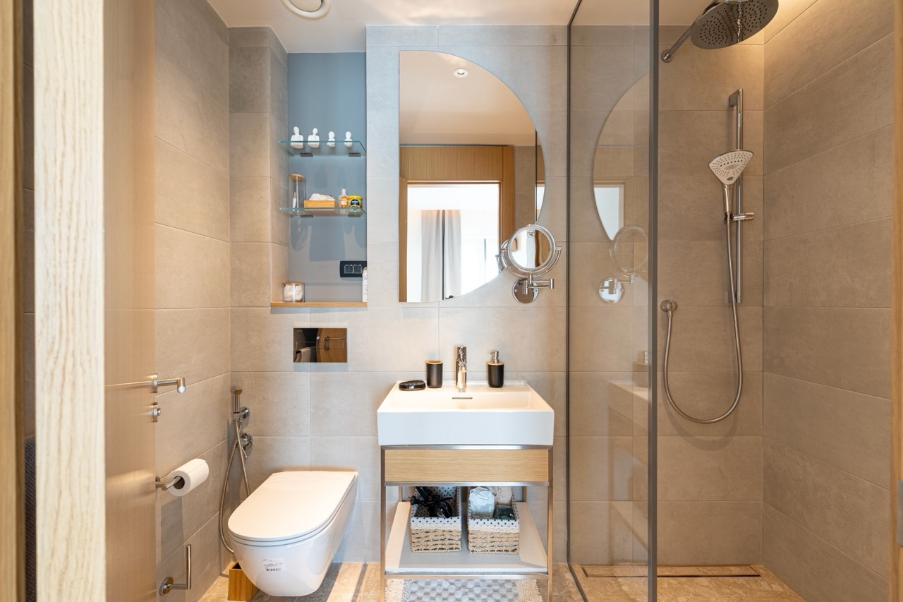 Modern bathroom in an apartment in Porto Montenegro, Tivat, Montenegro: shower cabin, stylish sink, and mirror.