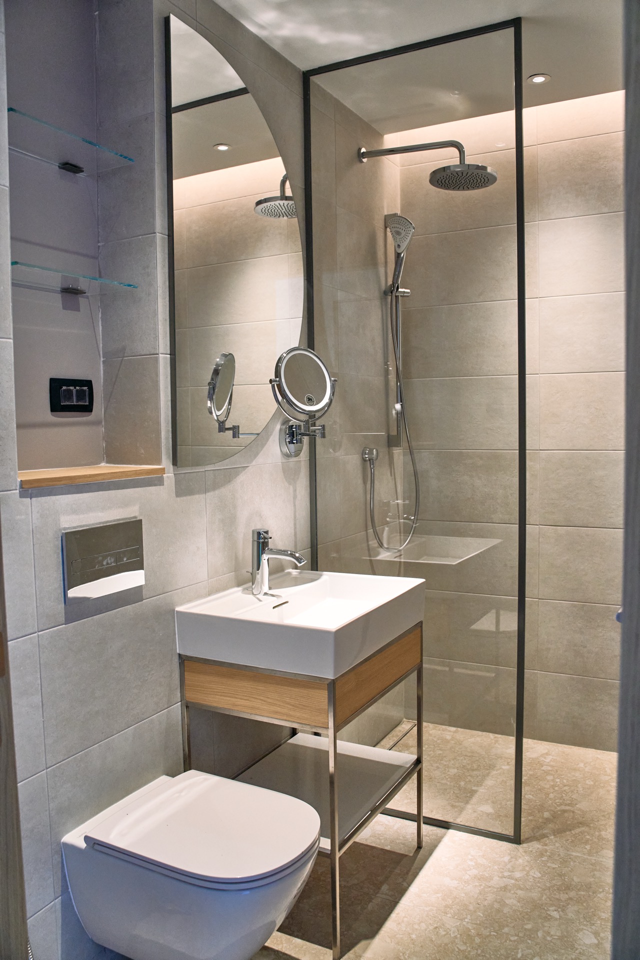 Modern bathroom in an apartment in Porto Montenegro, Tivat, Montenegro: shower cabin, stylish vanity, and mirror.
