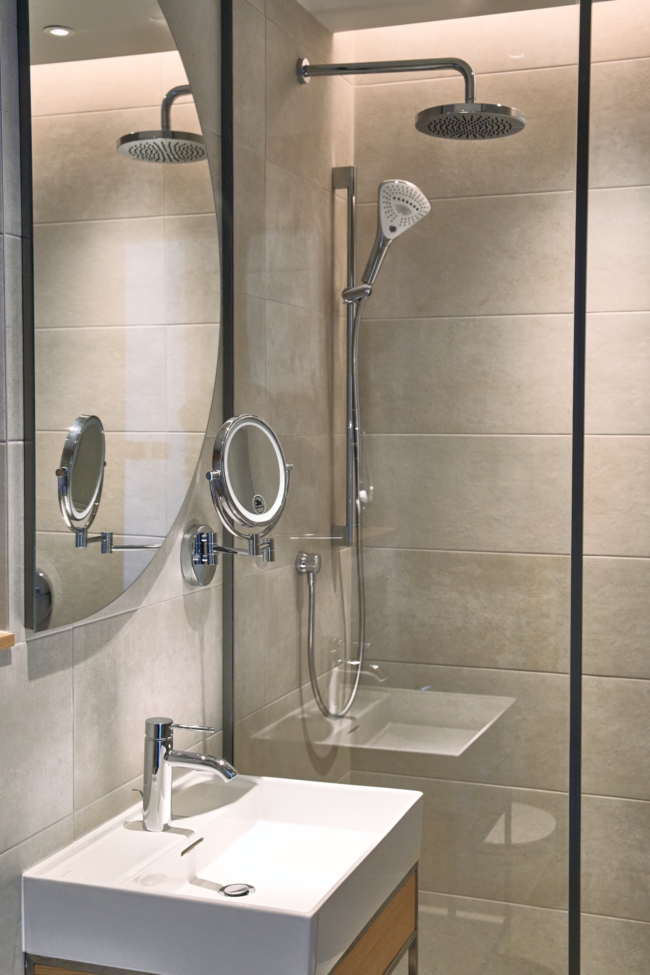Modern bathroom in an apartment in Porto Montenegro, Tivat, Montenegro: shower cabin, stylish fixtures, and mirror.