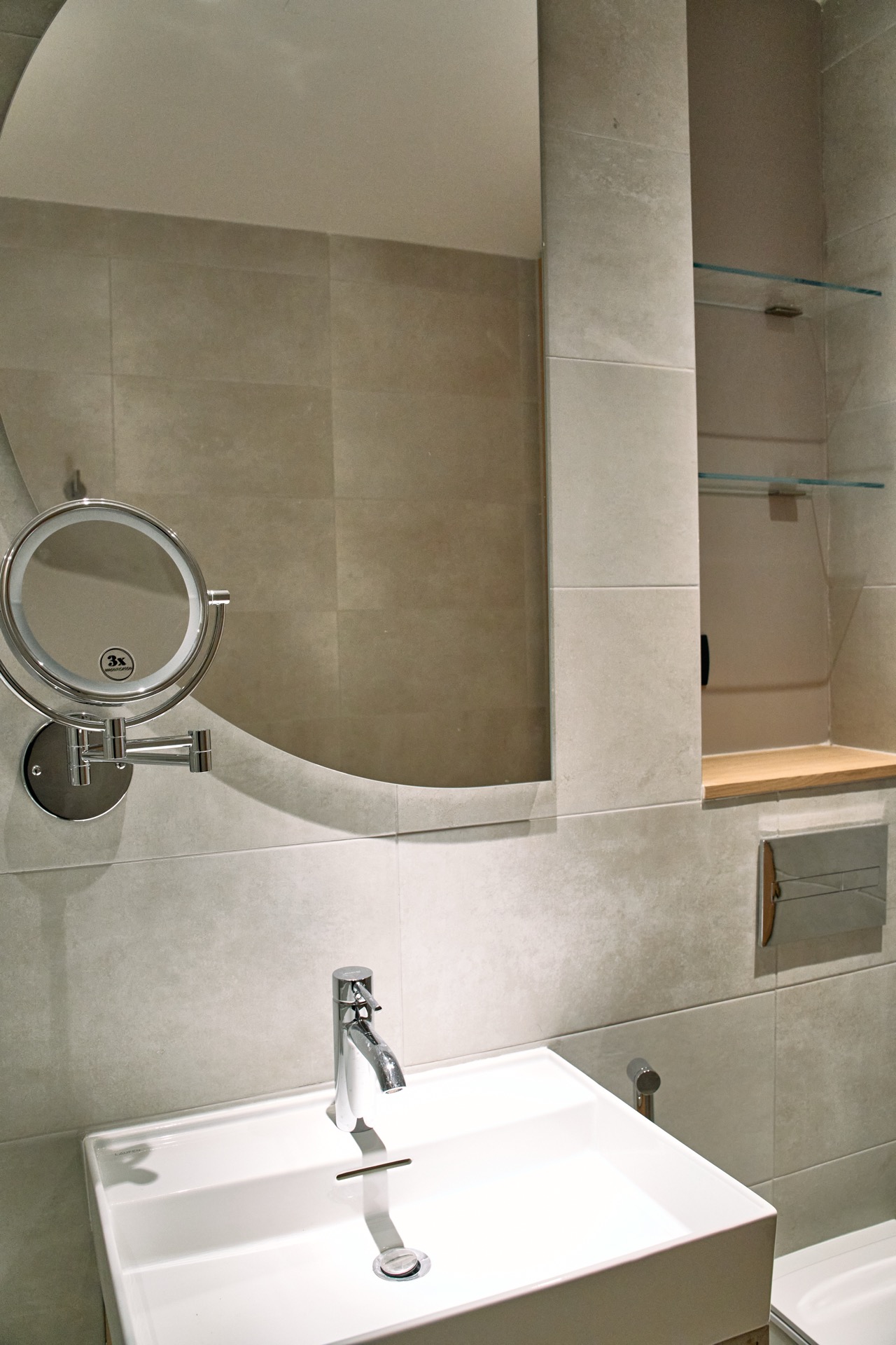 Modern bathroom in an apartment in Porto Montenegro, Tivat, Montenegro: stylish sink, mirror, and shelves.