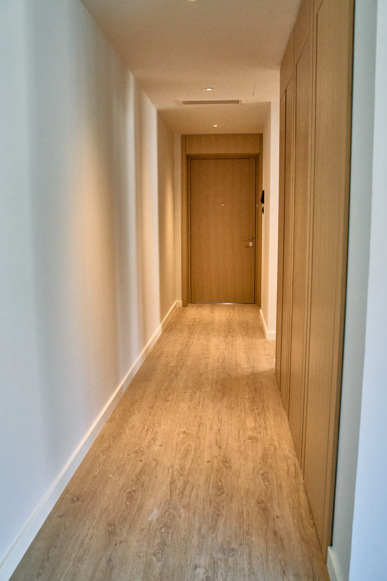 Modern bright hallway with wood finishes in an apartment in Porto Montenegro, Tivat, Montenegro.