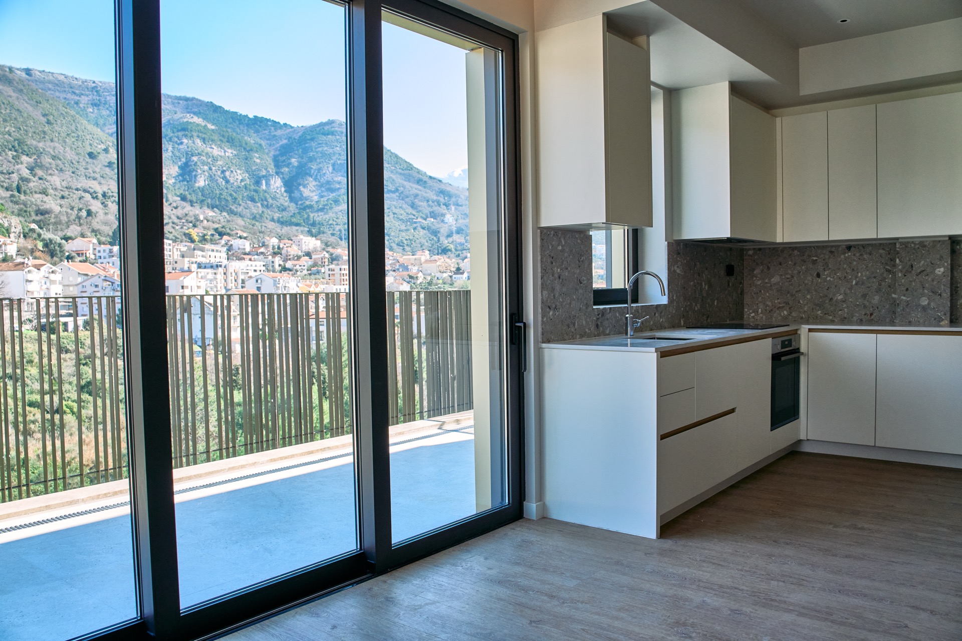 Modern kitchen in an apartment in Porto Montenegro, Tivat, Montenegro, with panoramic mountain views and a terrace.