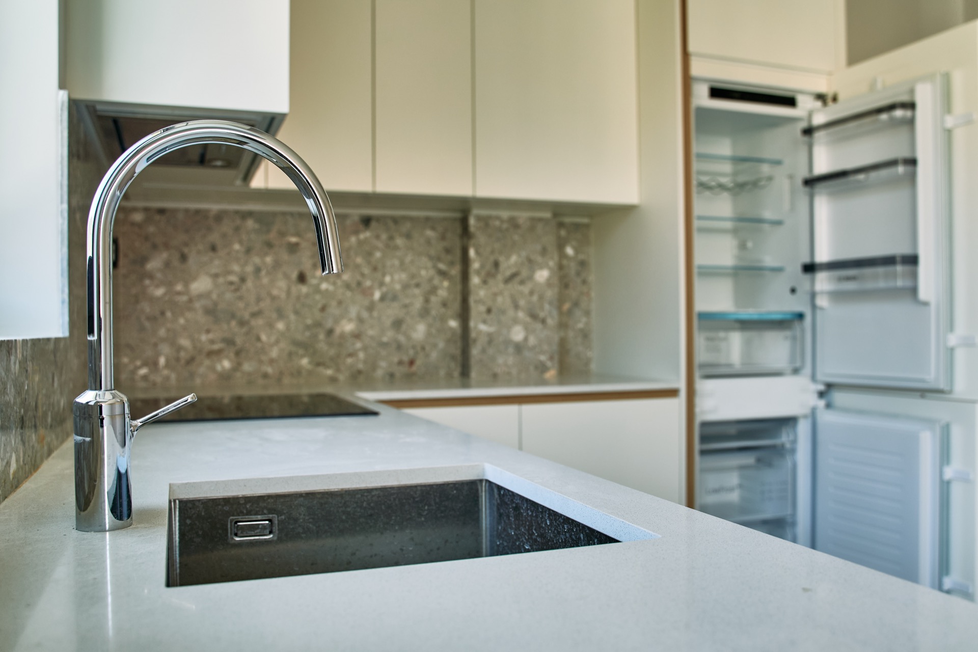 Modern kitchen with a stone countertop and built-in refrigerator in an apartment, Porto Montenegro, Tivat, Montenegro.