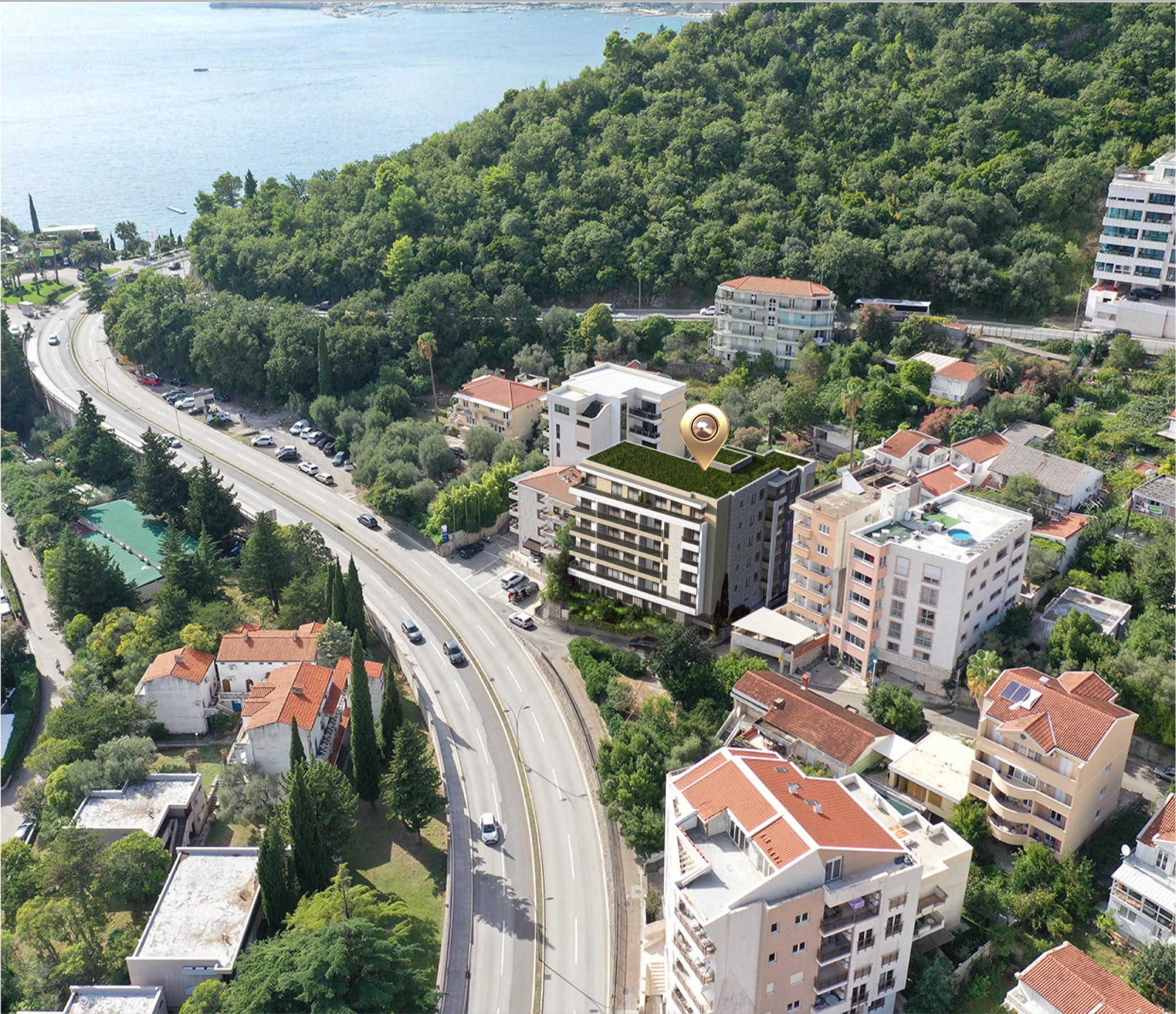 Aerial view of a new residential complex in Bečići, Montenegro, located near the sea and the city's developed infrastructure.