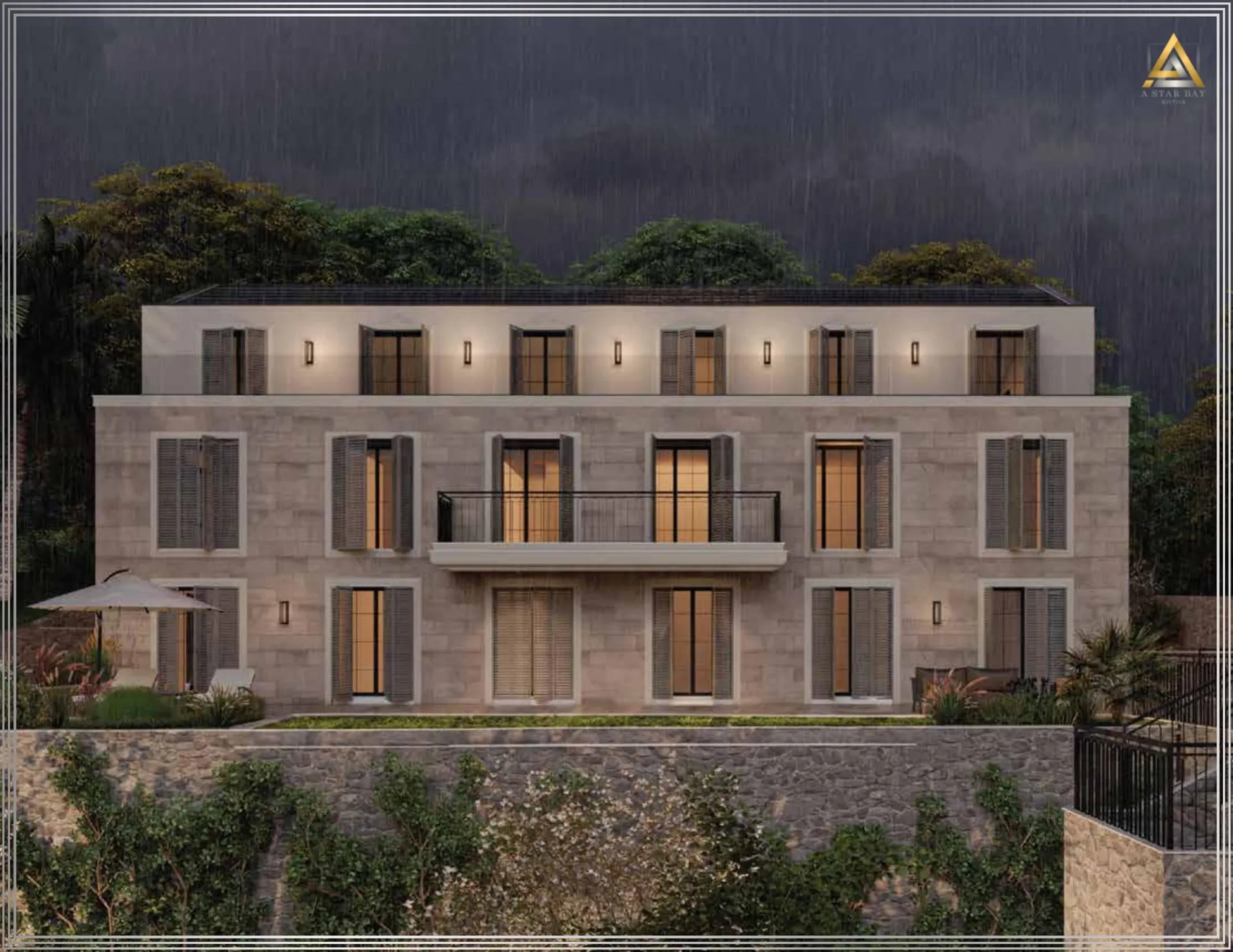 View of a modern three-story house with a stone facade, balcony, and shutters during rain at dusk.