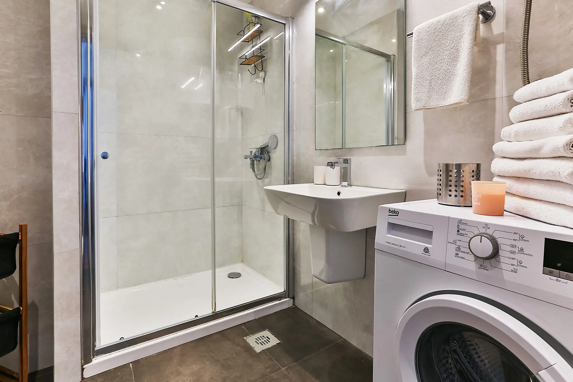Modern bathroom with a shower cabin and washing machine in an apartment, Budva, Montenegro.