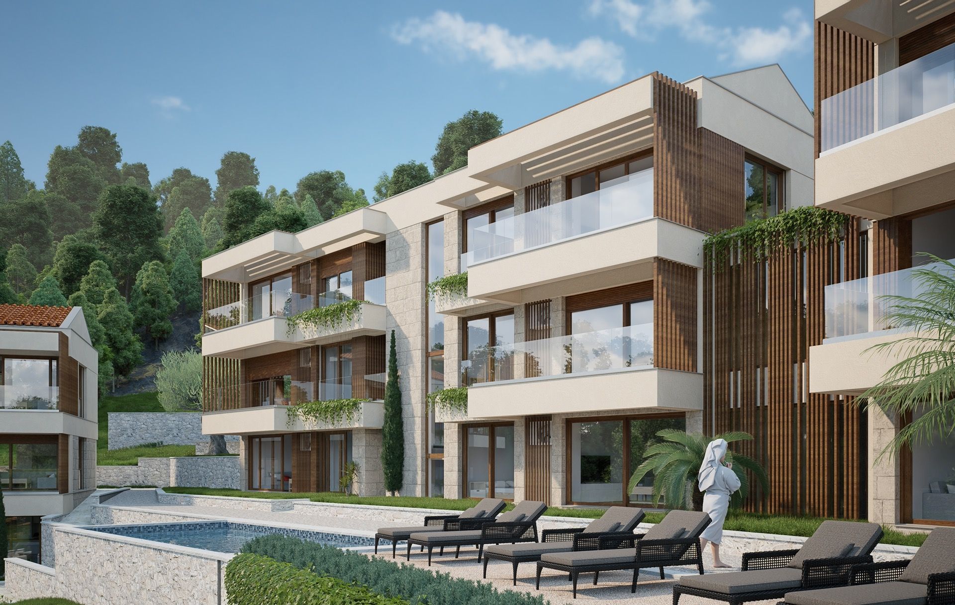 Modern residential complex with a pool and terraces in Blizikuće, Montenegro: view of the facade and relaxation area.