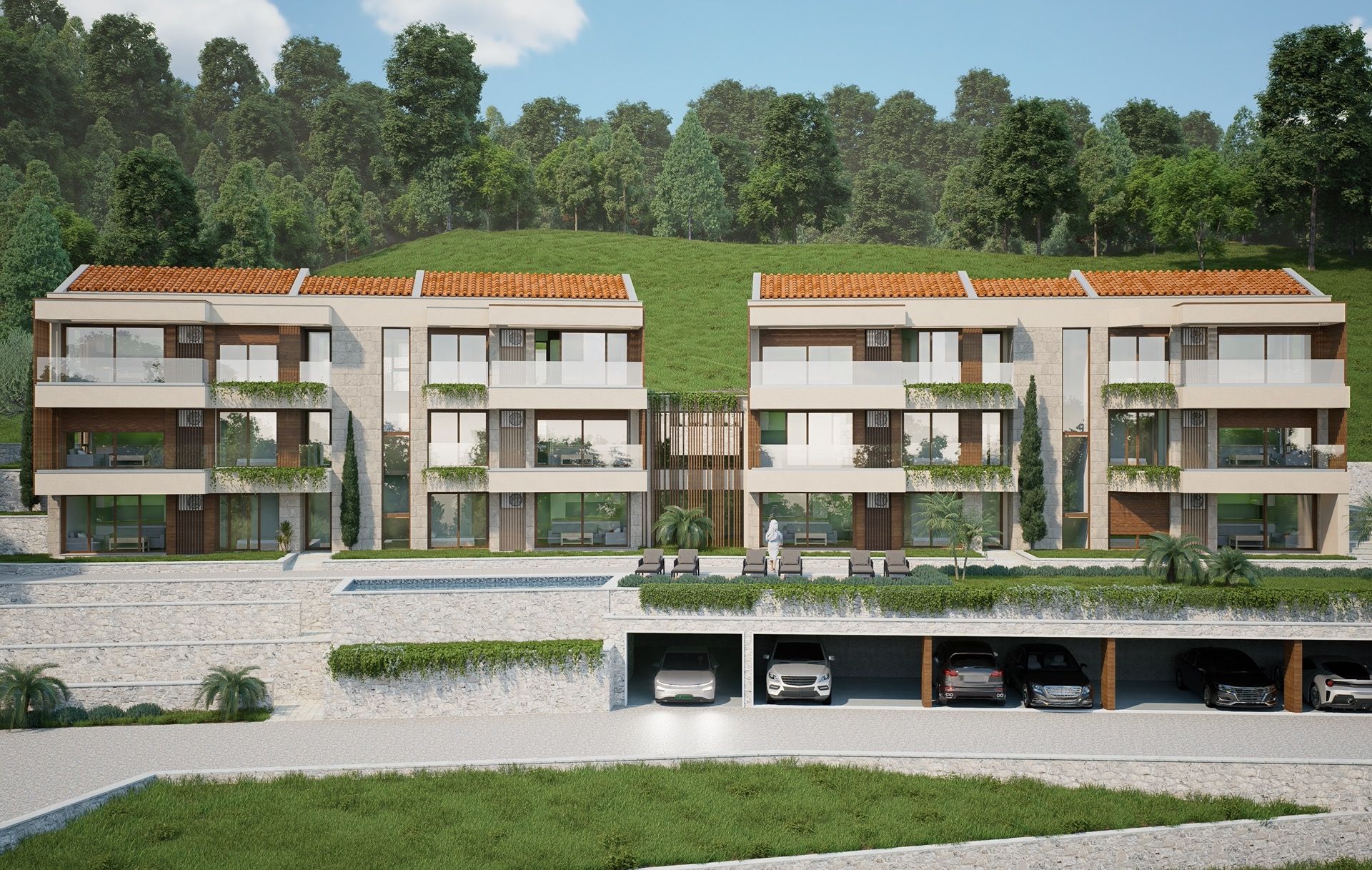 Modern residential complex with a pool and parking in Blizikuće, Montenegro: view of the building facades with terraces.