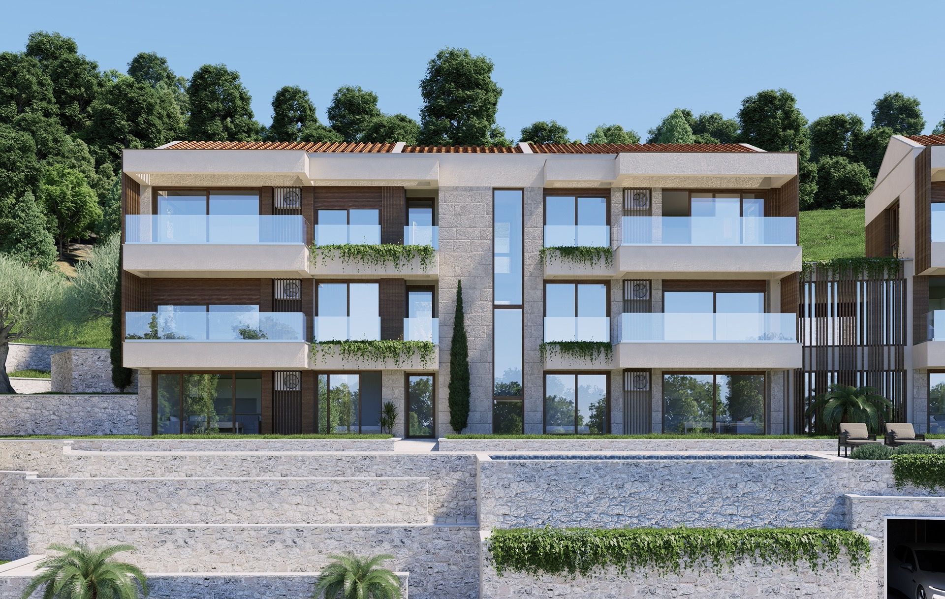 Modern residential complex with terraces and a pool in Blizikuće, Montenegro: stone facade and panoramic windows.
