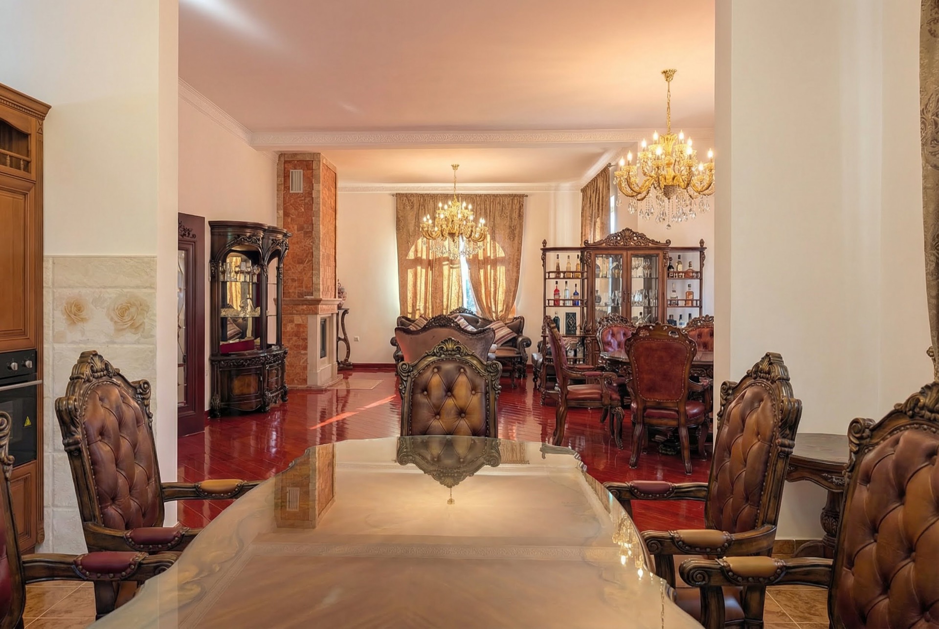 Luxurious living room with classic furniture and a fireplace in a villa in Luštica, Montenegro. Interior with crystal chandeliers.
