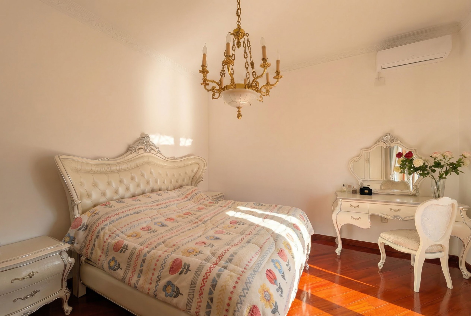 Bedroom in a classic style in a villa in Luštica, Montenegro: a double bed, vanity table, and a gold chandelier.