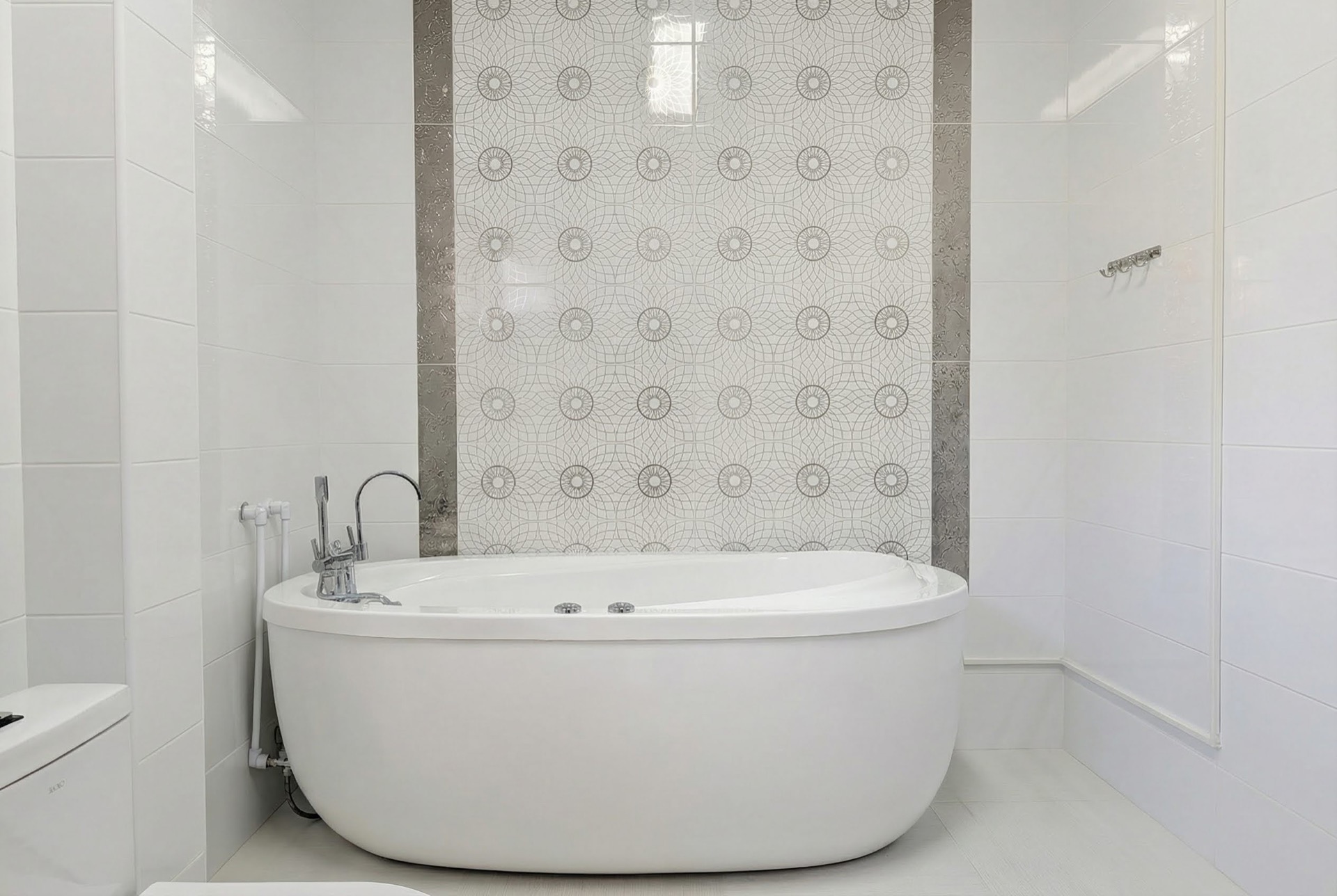 Modern bathroom with an oval bathtub and decorative tiles in a villa in Luštica Bay, Montenegro.
