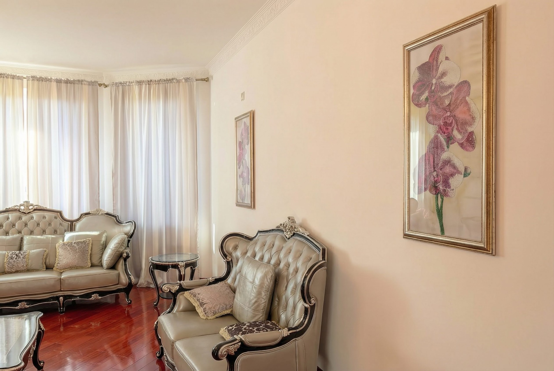 Bright living room with classic leather furniture in a luxury villa in Luštica, Montenegro: parquet flooring and wall decor.