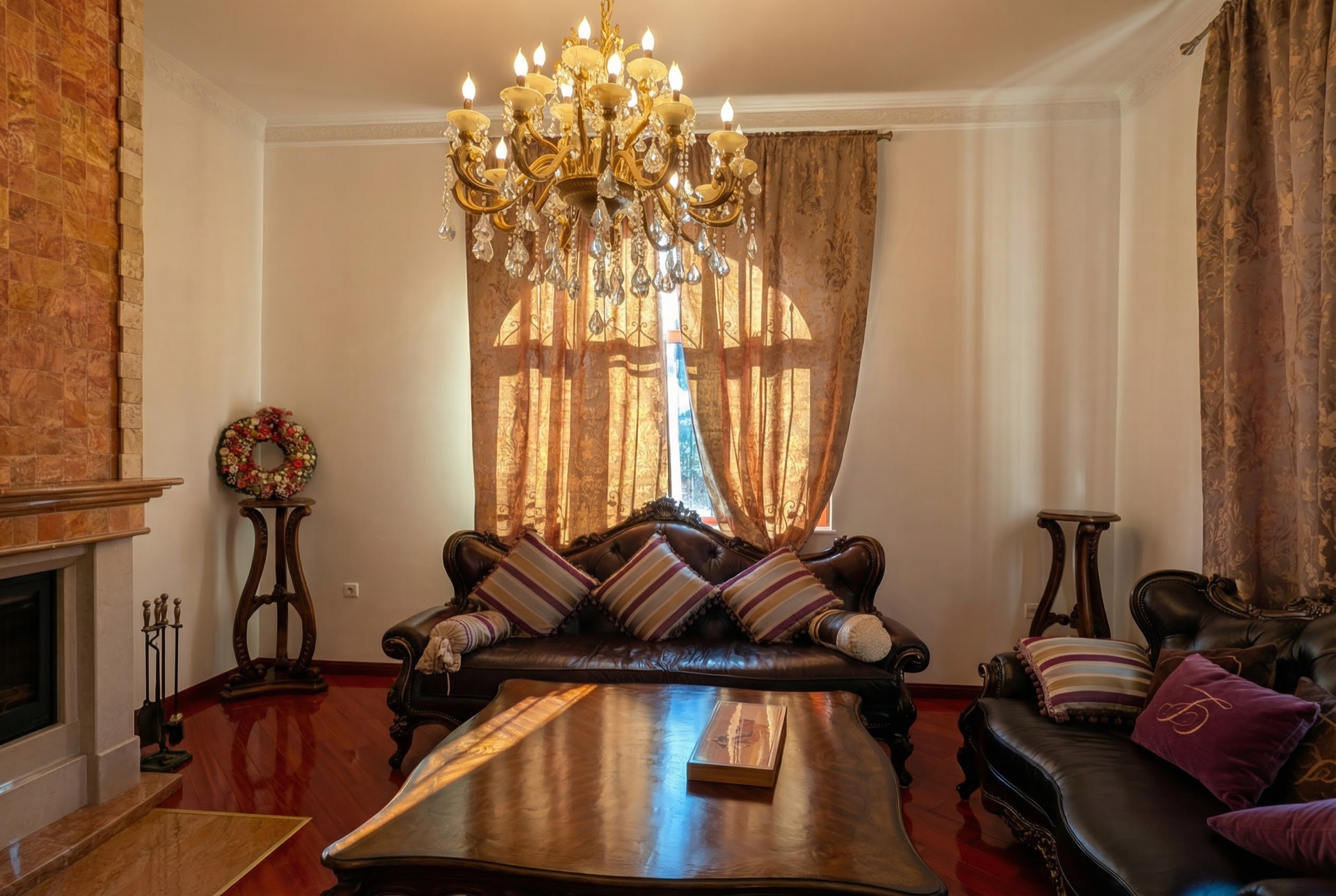 Luxurious living room with a fireplace and leather furniture in a villa in Luštica, Montenegro: classic interior with a chandelier.