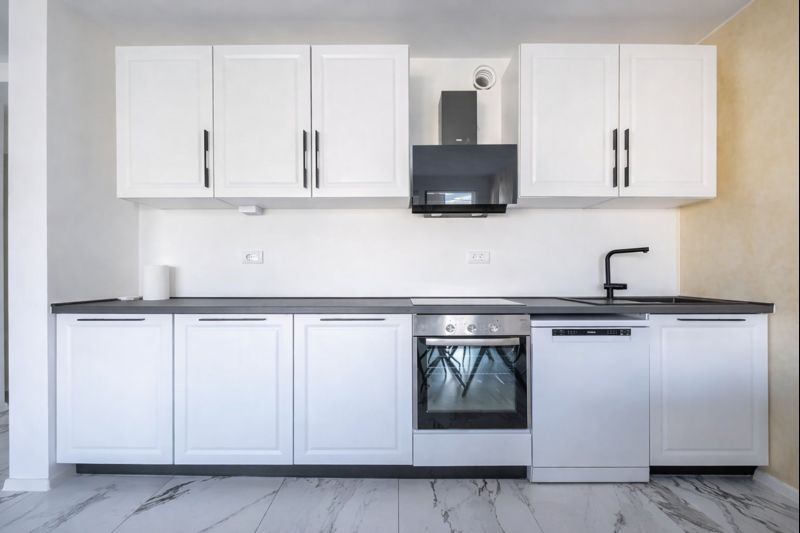 Modern white kitchen with appliances in a townhouse in Luštica, Montenegro