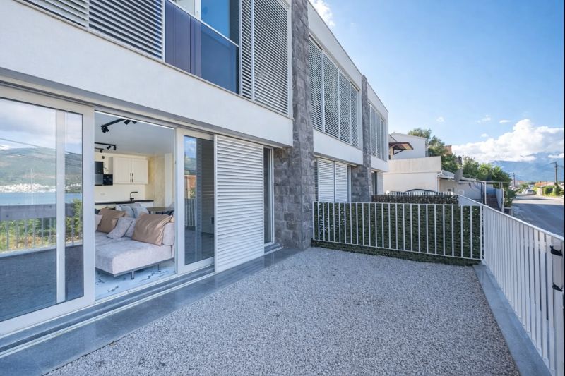 Modern townhouse with a terrace, panoramic windows, and sea view in Luštica, Montenegro