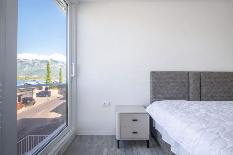 Bedroom with panoramic window and mountain view in a townhouse, Luštica, Montenegro