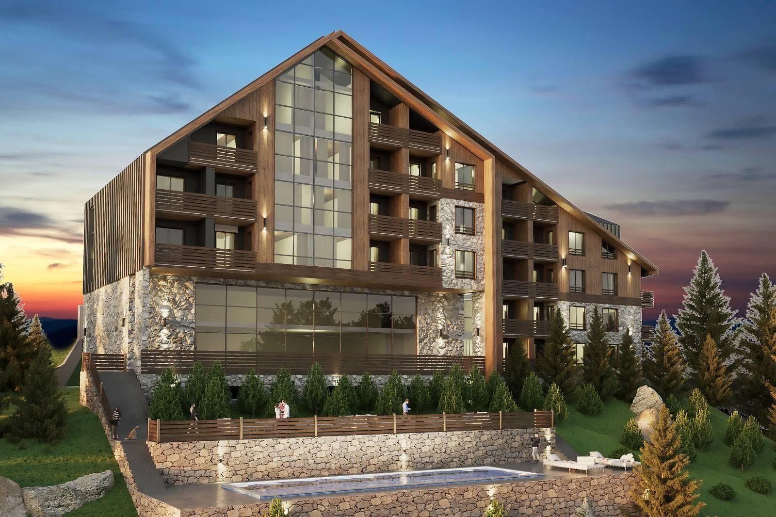 Modern mountain hotel in Kolašin, Montenegro: wooden and stone facade, panoramic windows, and an outdoor pool.
