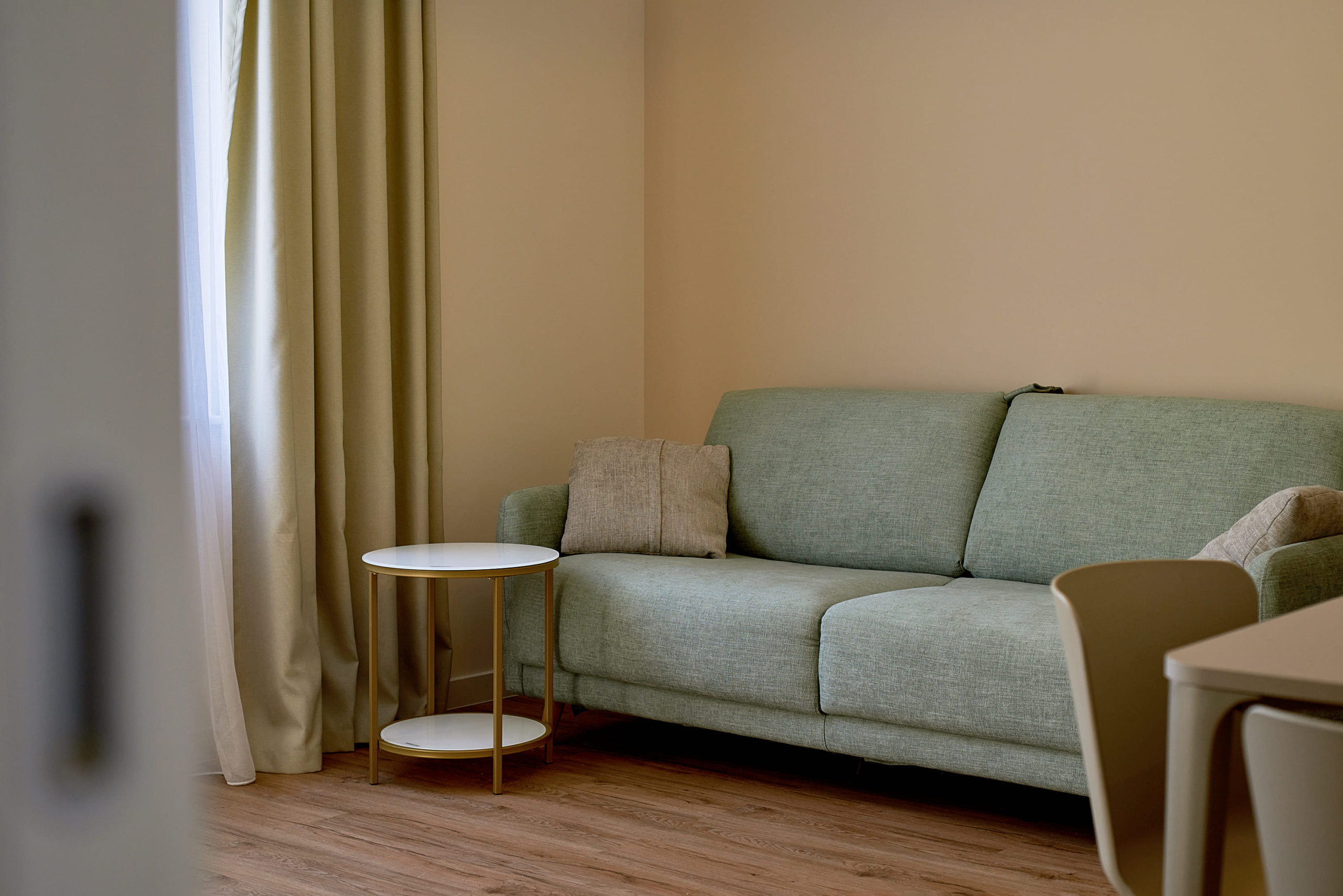 Bright living room with a green sofa and coffee table in an apartment, Bečići, Montenegro.