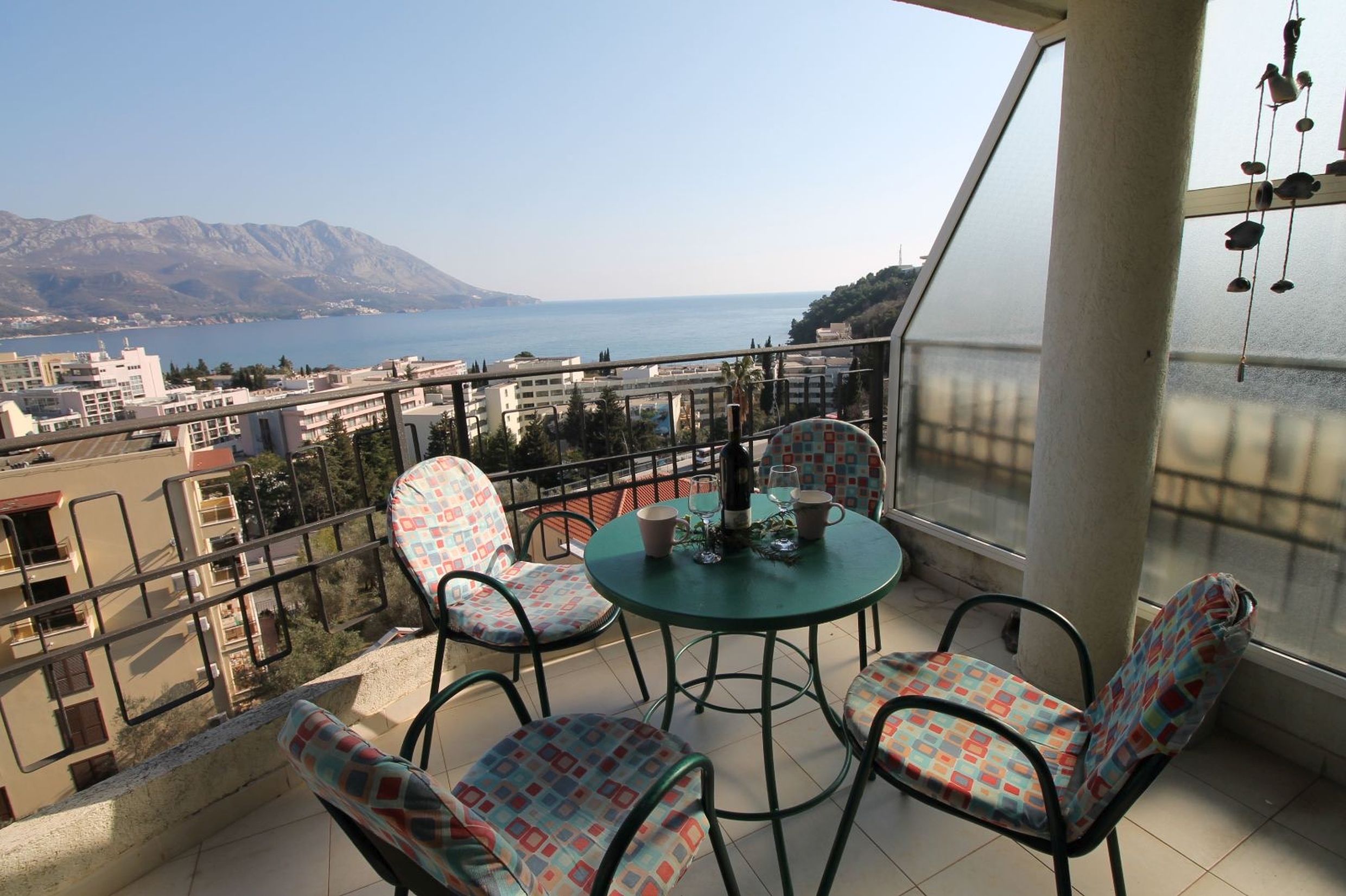 Balcony with furniture and panoramic sea and mountain views in the apartment, Bečići, Montenegro.