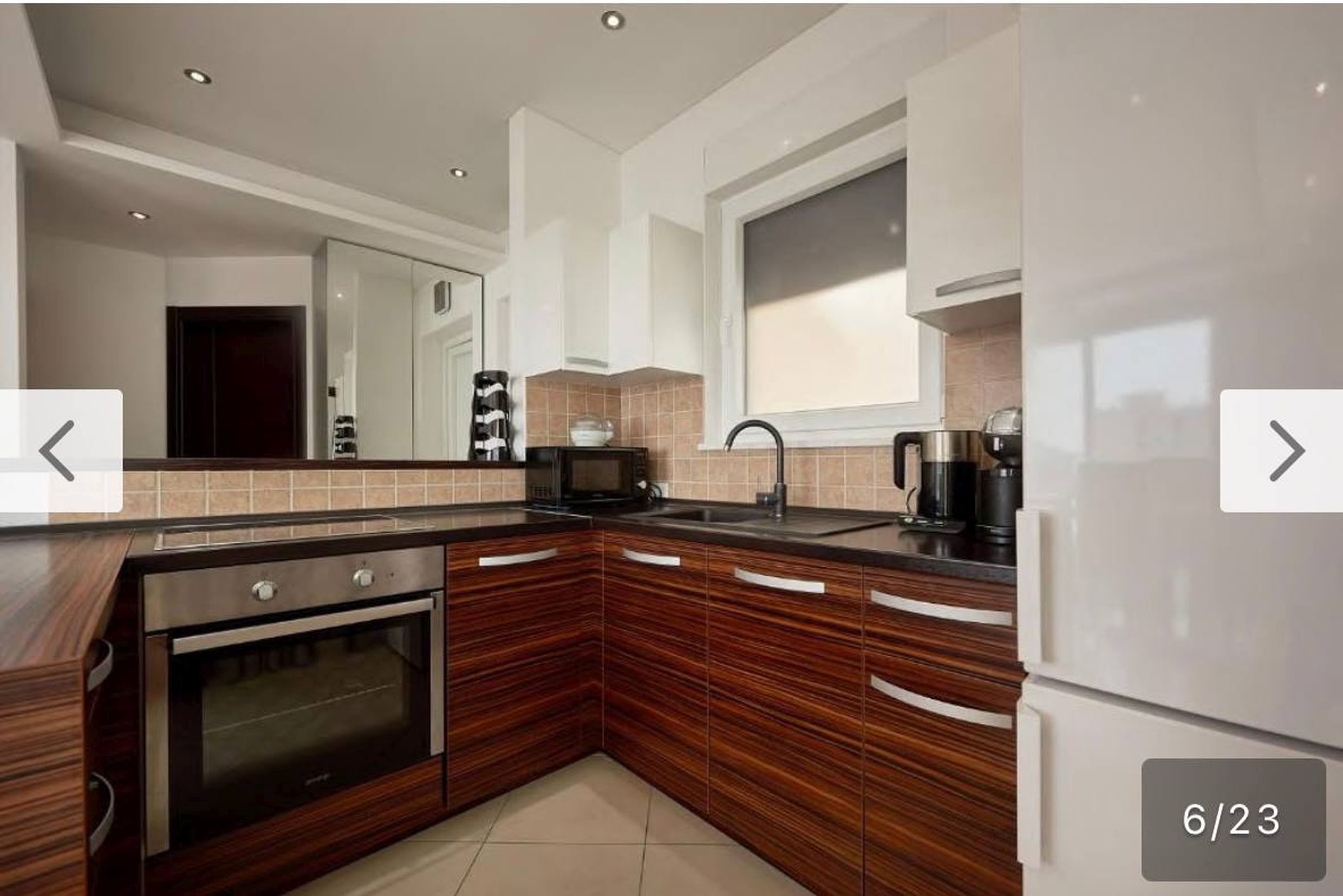 Modern kitchen with dark facades and built-in appliances in an apartment in Bečići, Montenegro.