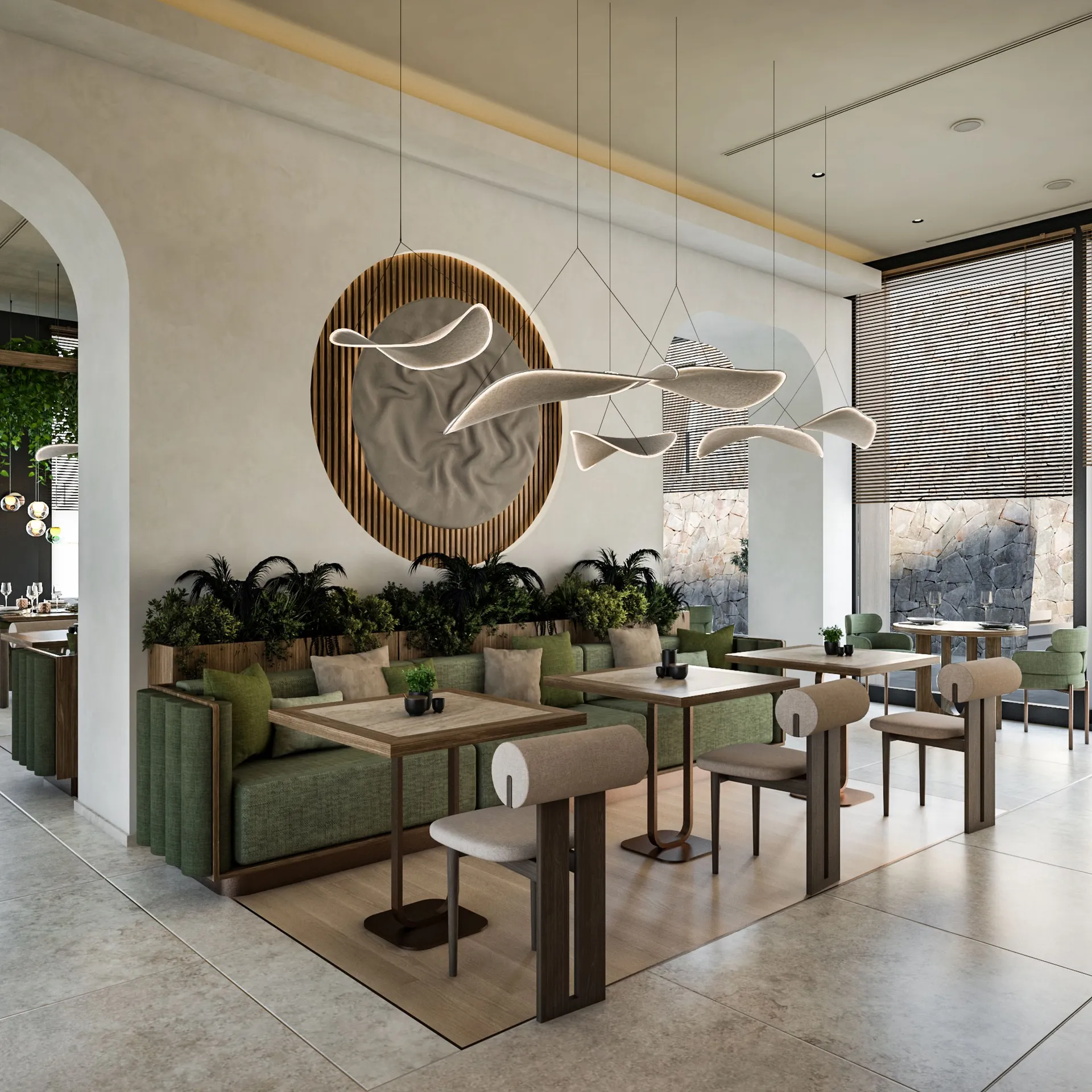 Modern restaurant interior featuring green banquette seating, wooden tables, and sculptural pendant lights above a circular wall decoration.