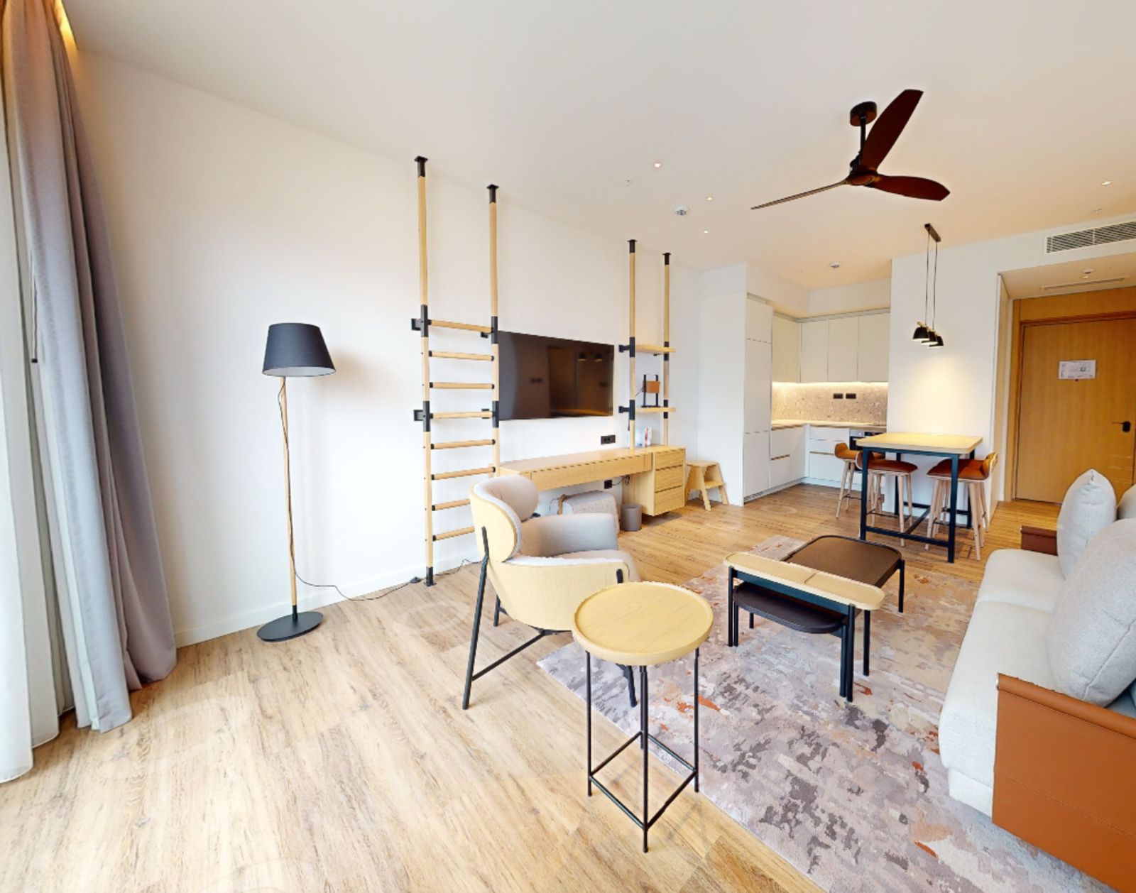 Modern living room with kitchen in an apartment in Tivat, Montenegro: bright interior, designer furniture, and TV area.