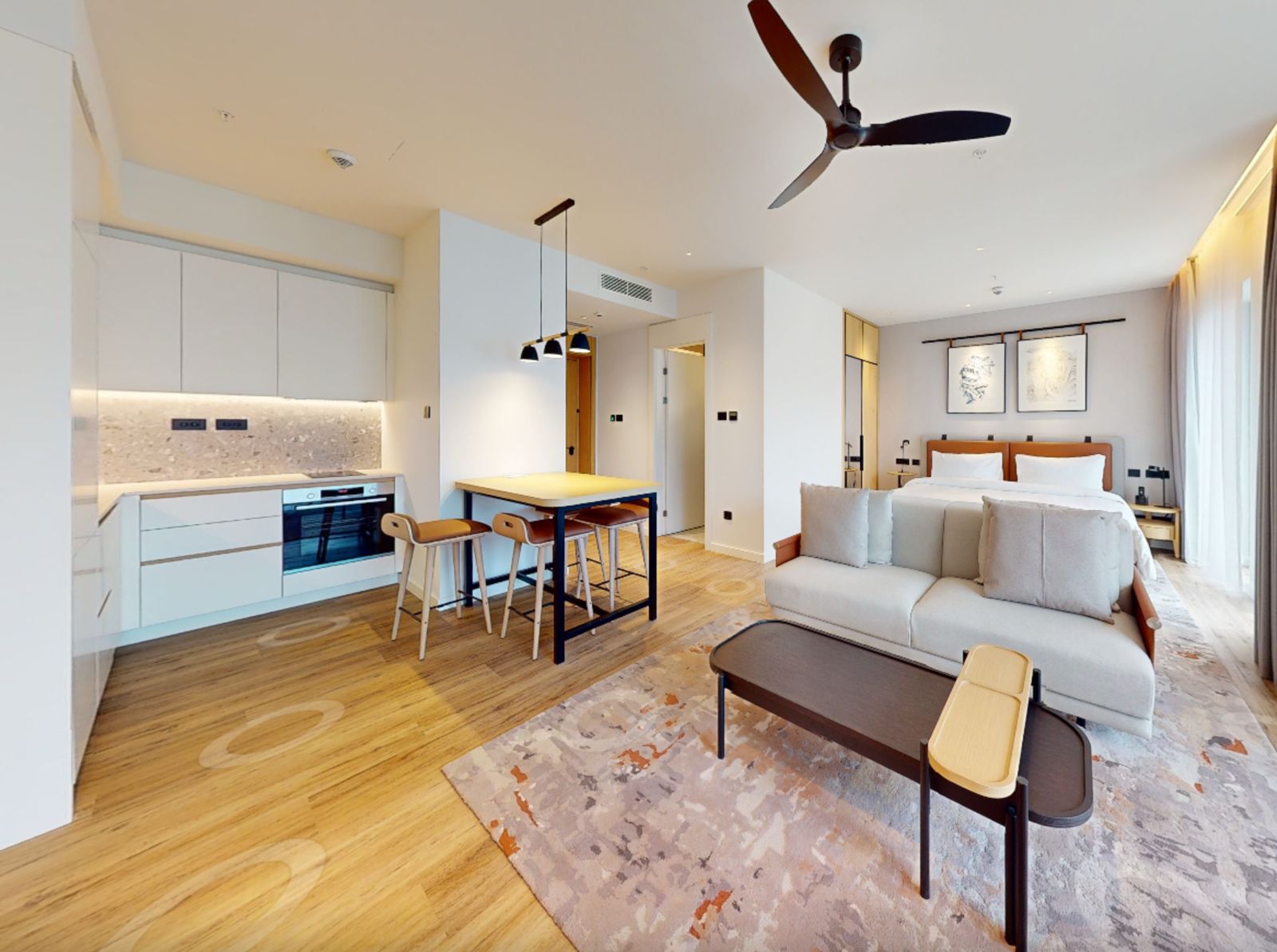 Modern studio with kitchen and sleeping area in Tivat, Montenegro: bright interior, wooden and textile furniture.