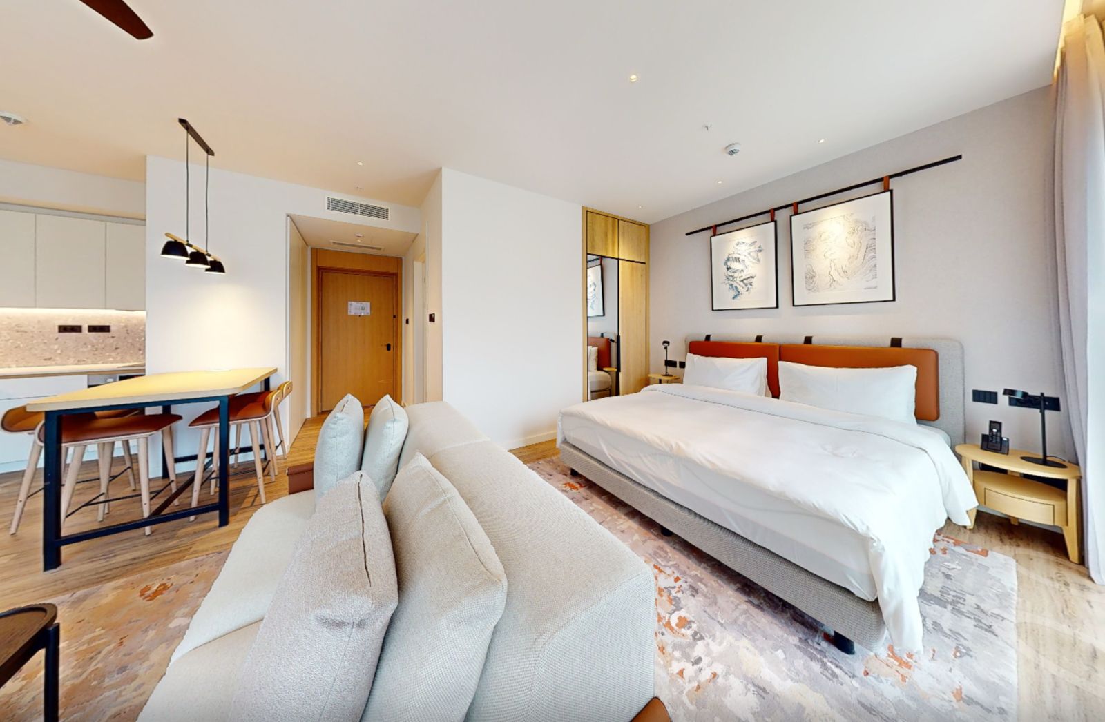 Modern bedroom with a double bed and kitchen in an apartment in Tivat, Montenegro: stylish interior and furniture.