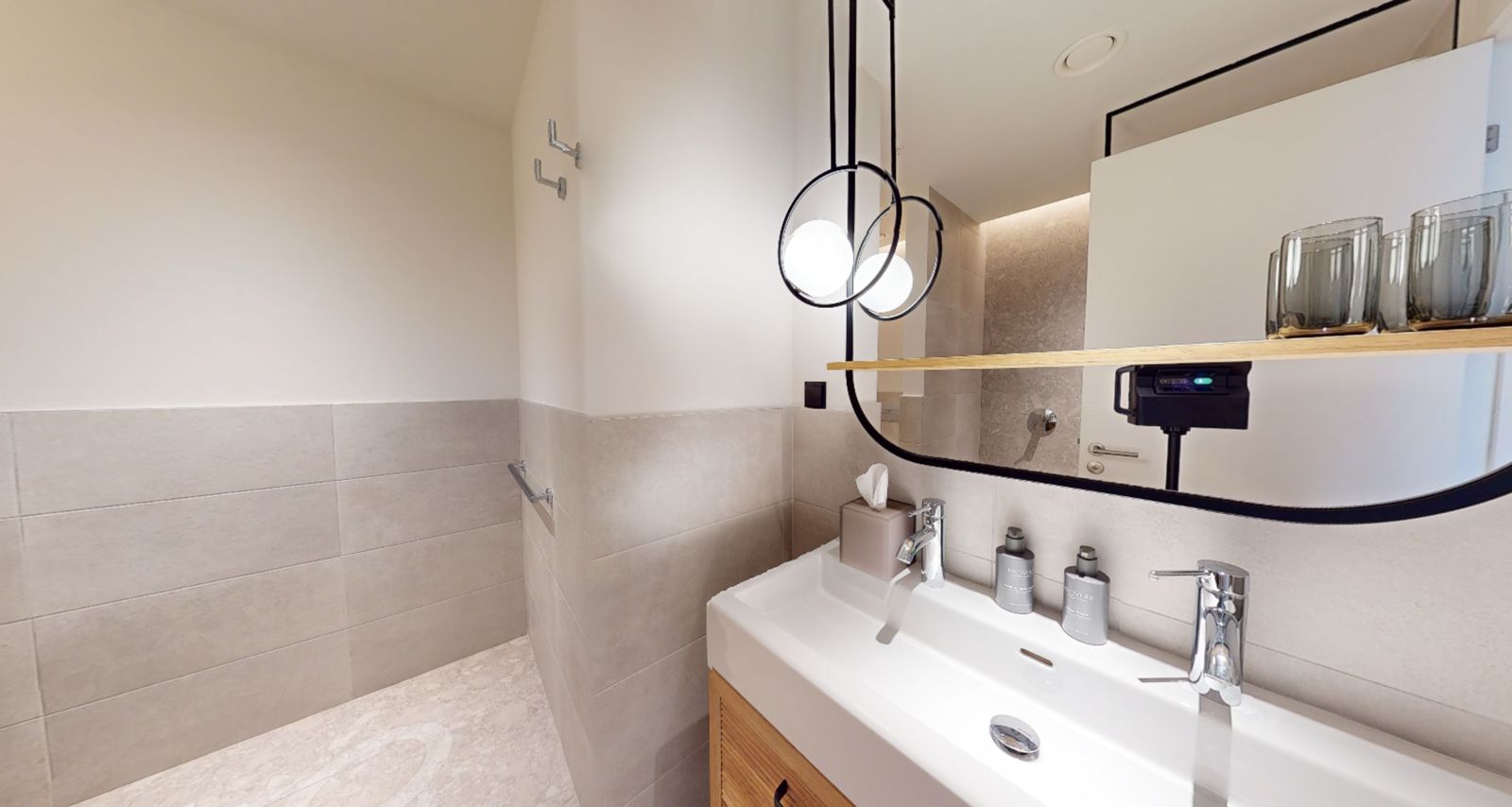 Modern bathroom in an apartment in Tivat, Montenegro: stylish vanity, mirror, and high-quality tile finish.