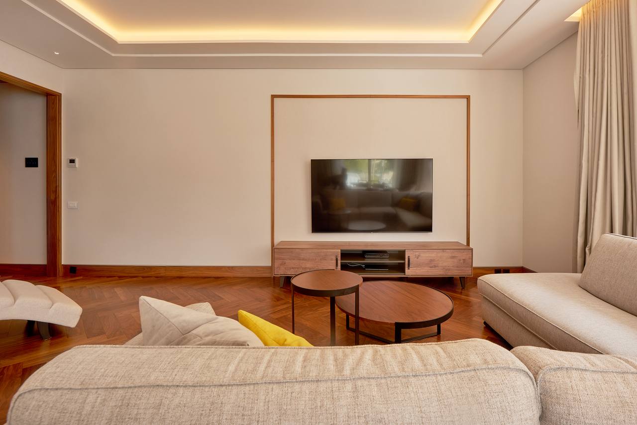 Modern living room with parquet flooring and TV area in an apartment in Porto Montenegro, Tivat, Montenegro.