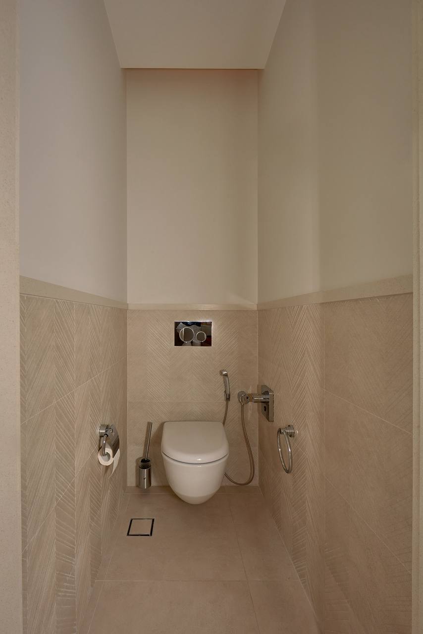 Modern bathroom with a wall-mounted toilet and bidet shower in an apartment, Porto Montenegro, Tivat, Montenegro