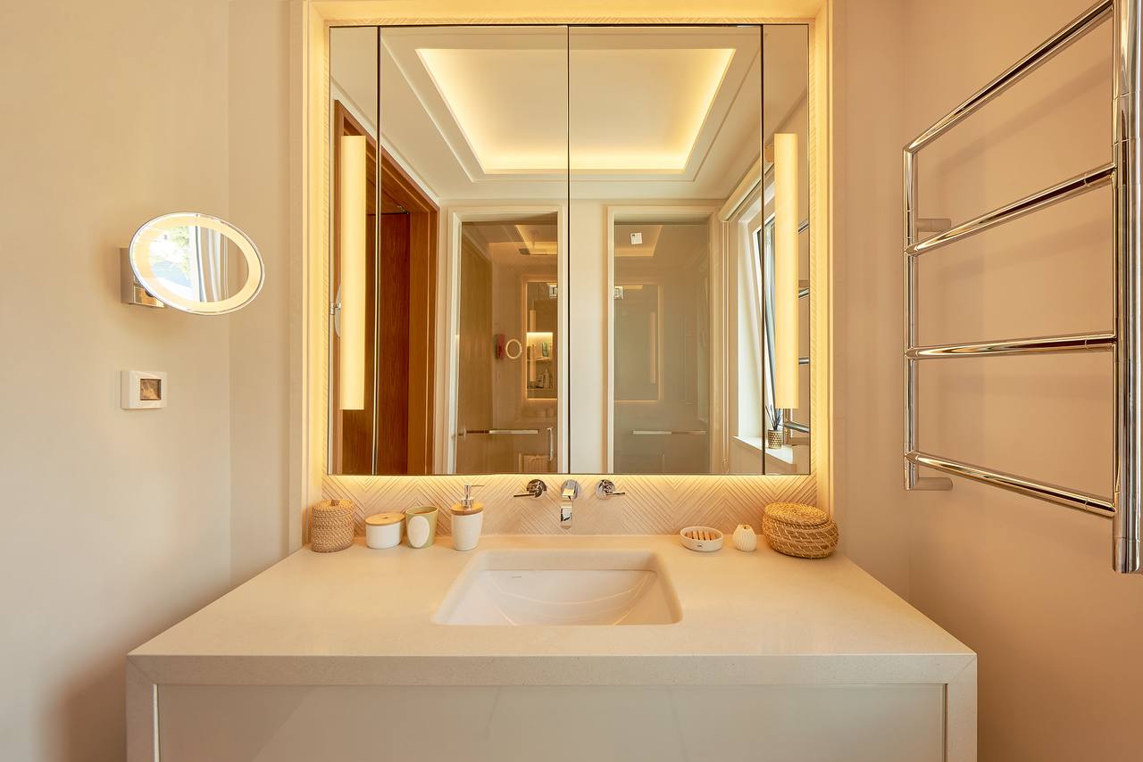 Modern bathroom with mirror lighting in an apartment in Porto Montenegro, Tivat, Montenegro.