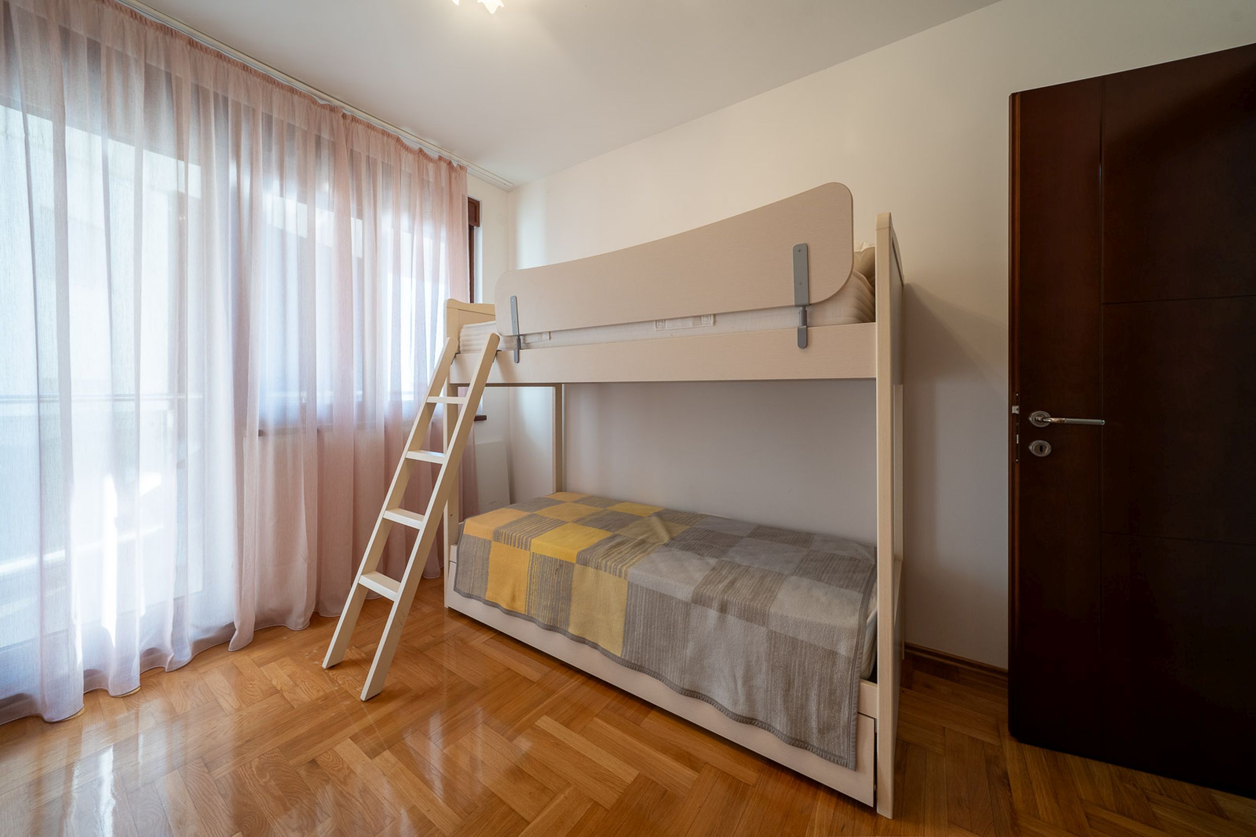 Children's bedroom with a bunk bed and parquet flooring in an apartment in Bečići, Montenegro.