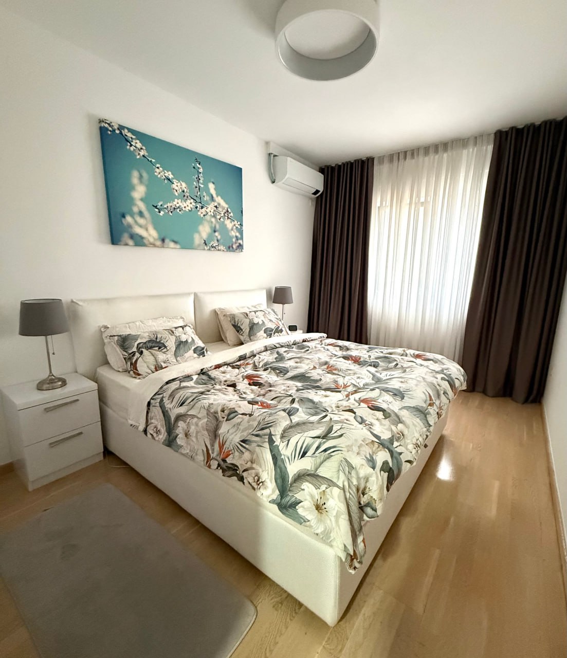 Cozy bedroom with a double bed and air conditioning in an apartment in Podgorica, Montenegro. Modern interior.
