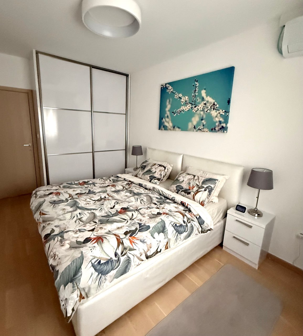 Bright bedroom in an apartment in Podgorica, Montenegro: double bed, built-in wardrobe, and modern finishes.