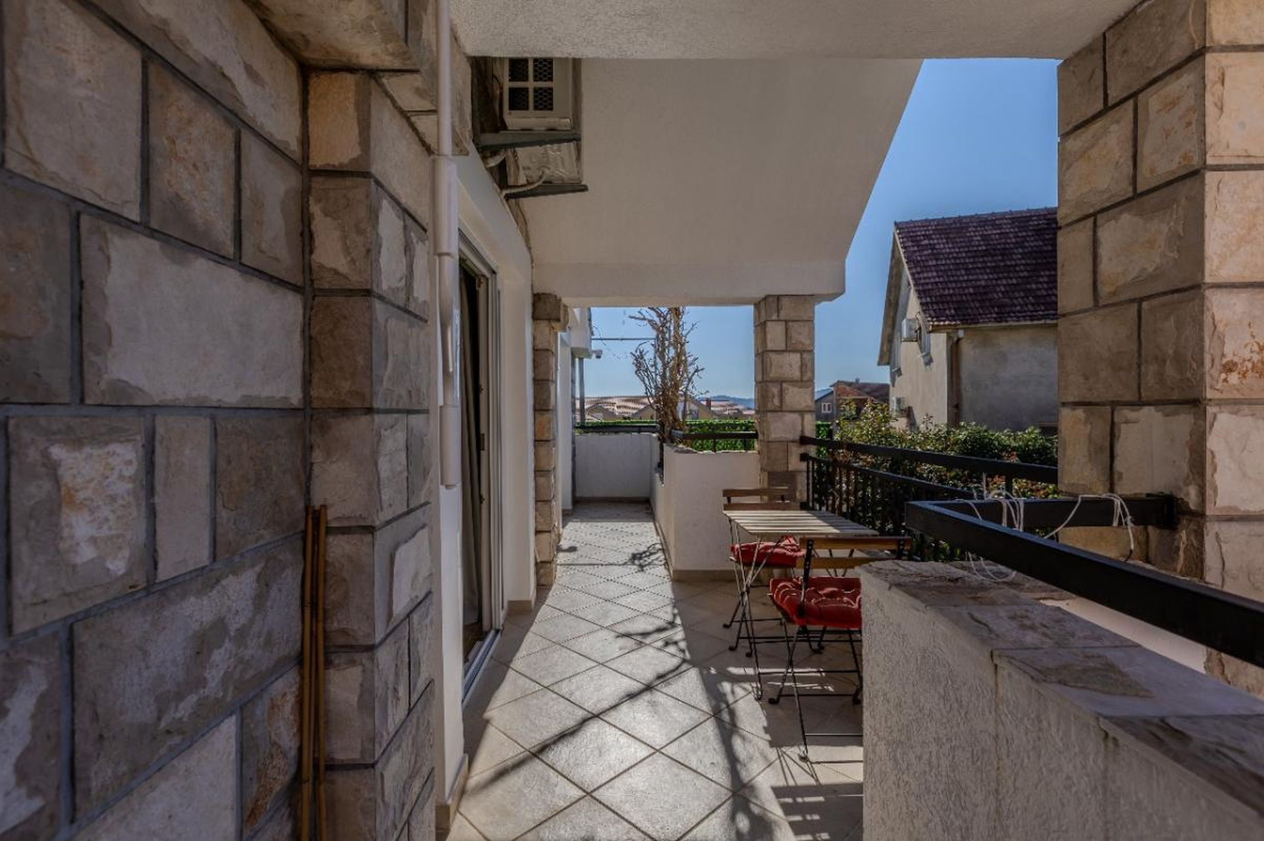 Cozy balcony with stone finishes and furniture in a house for sale in Tivat, Montenegro.