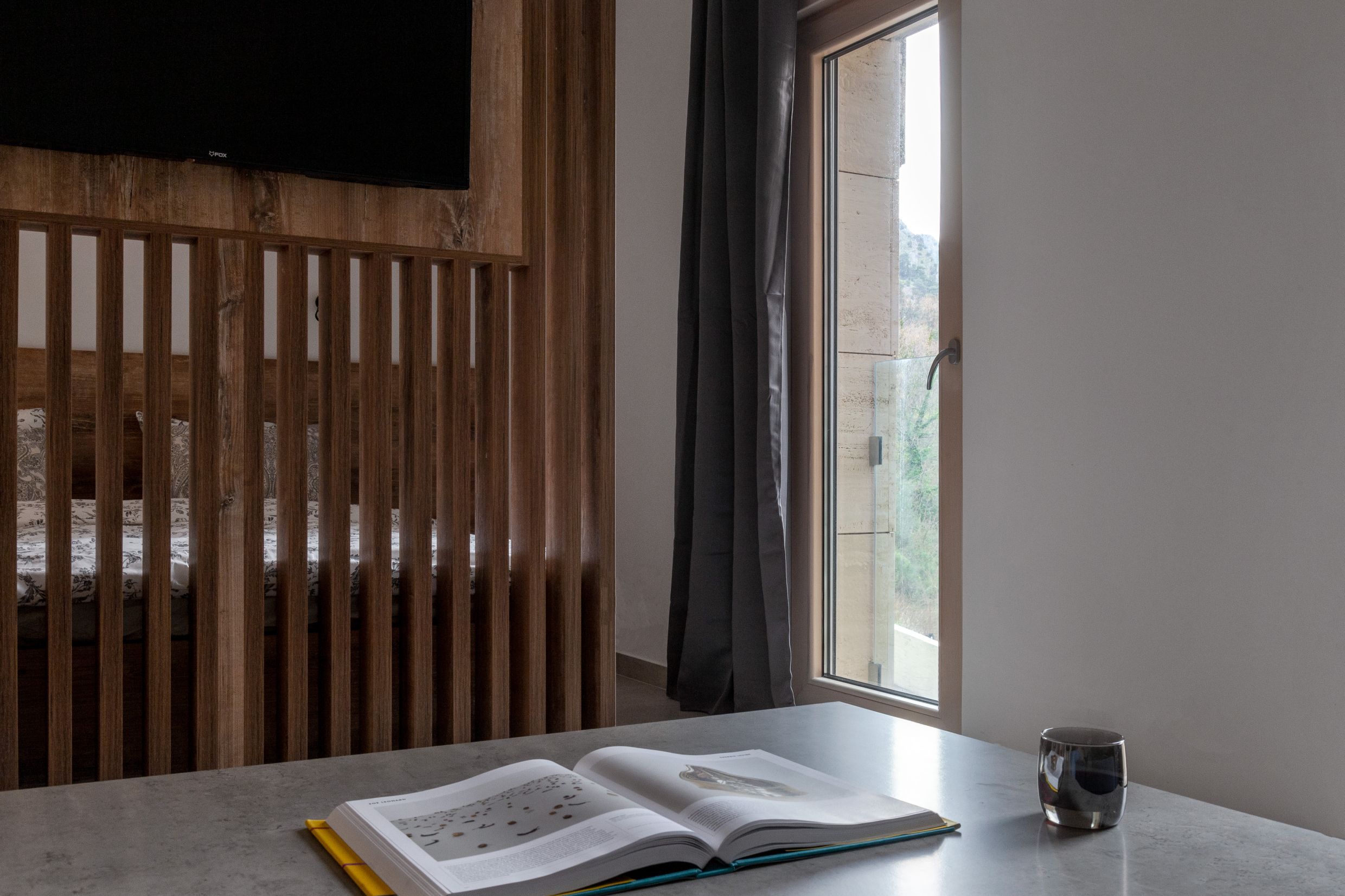 Living room interior with a wooden partition and mountain view in an apartment, Kotor, Montenegro.