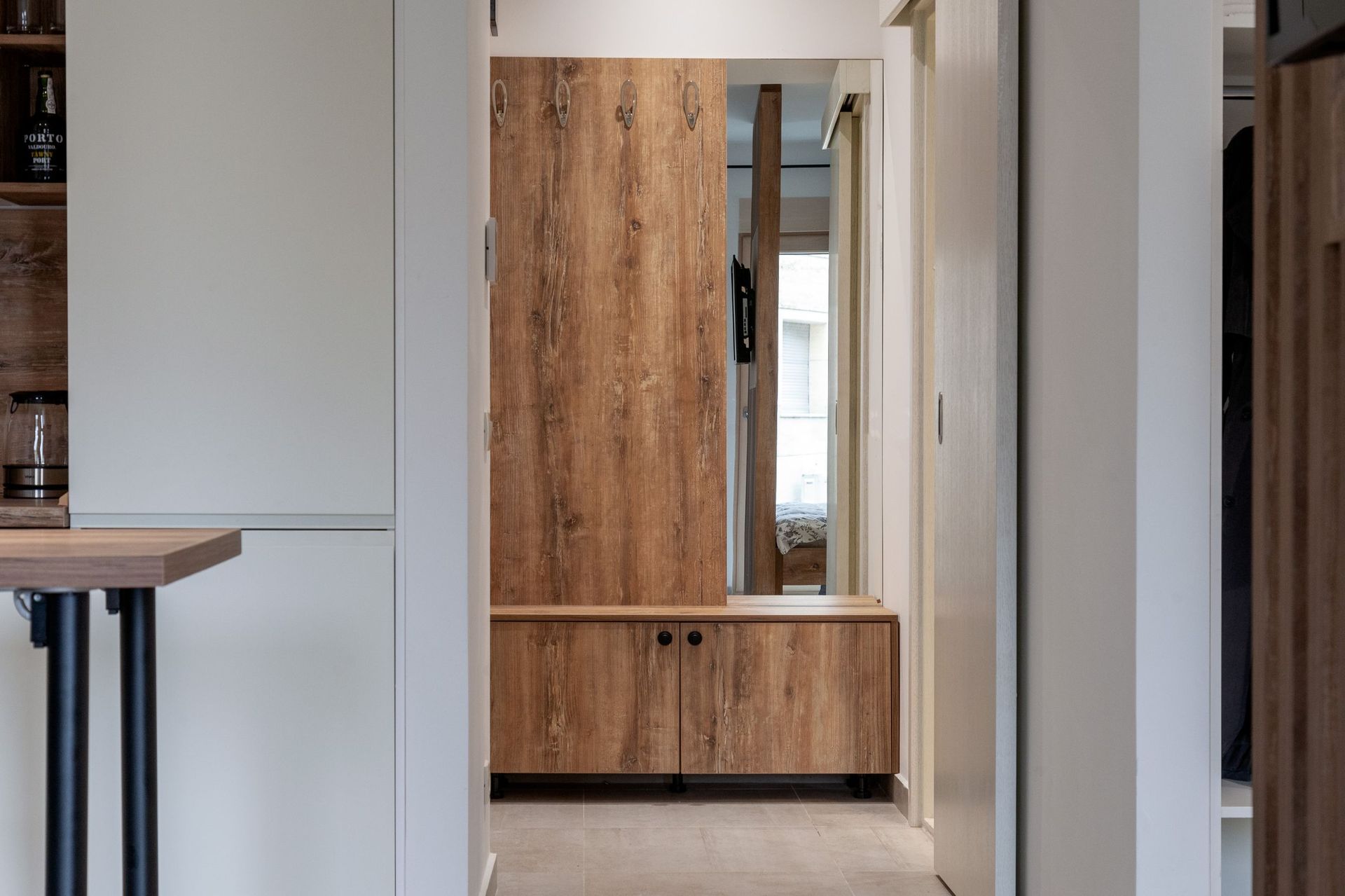 Modern hallway with wooden furniture and a mirror in an apartment in Kotor, Montenegro.