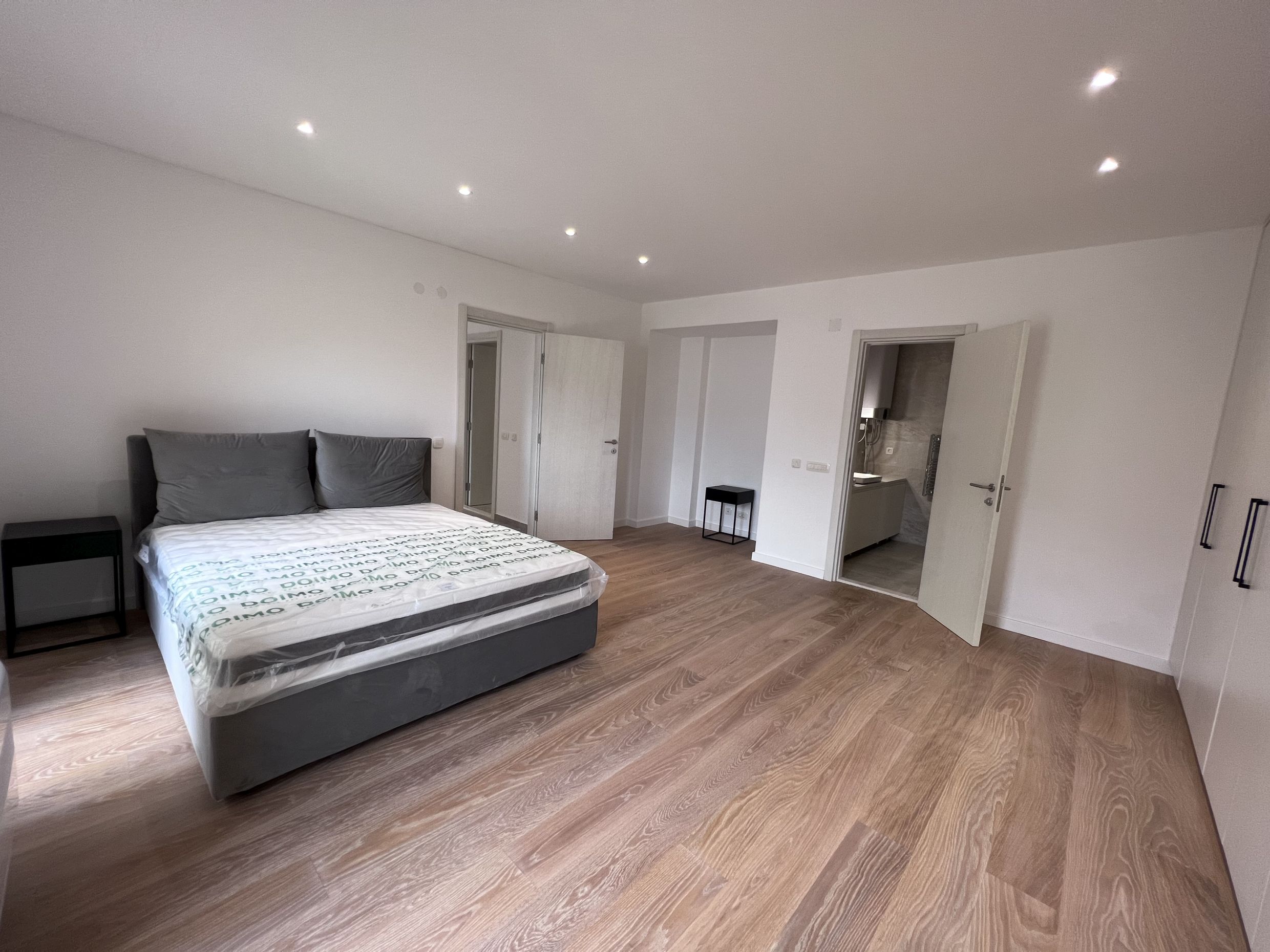 Modern bedroom with a double bed and bathroom in a new apartment, Kotor, Montenegro.