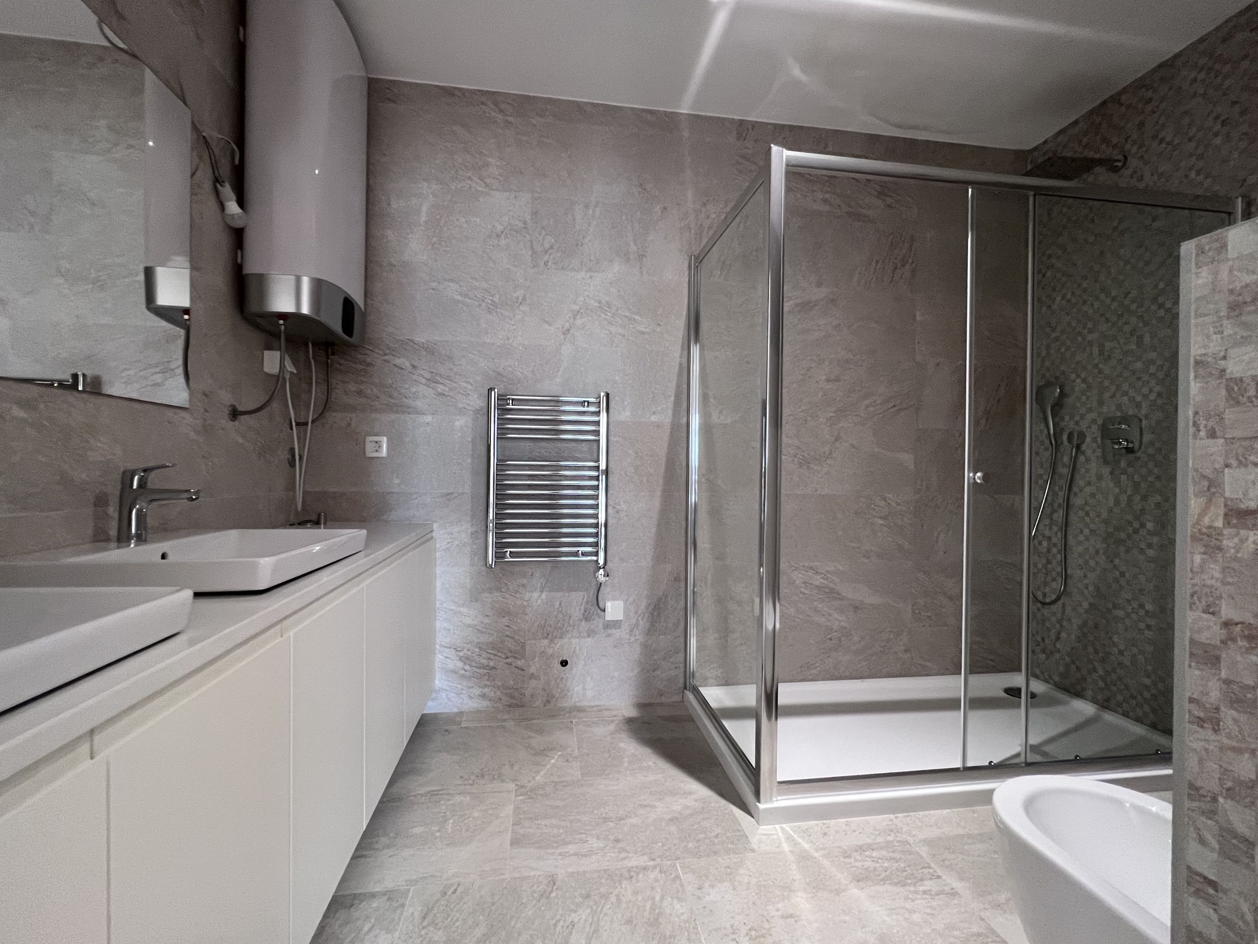 Modern bathroom with a shower cabin and light finishes in an apartment, Kotor, Montenegro.