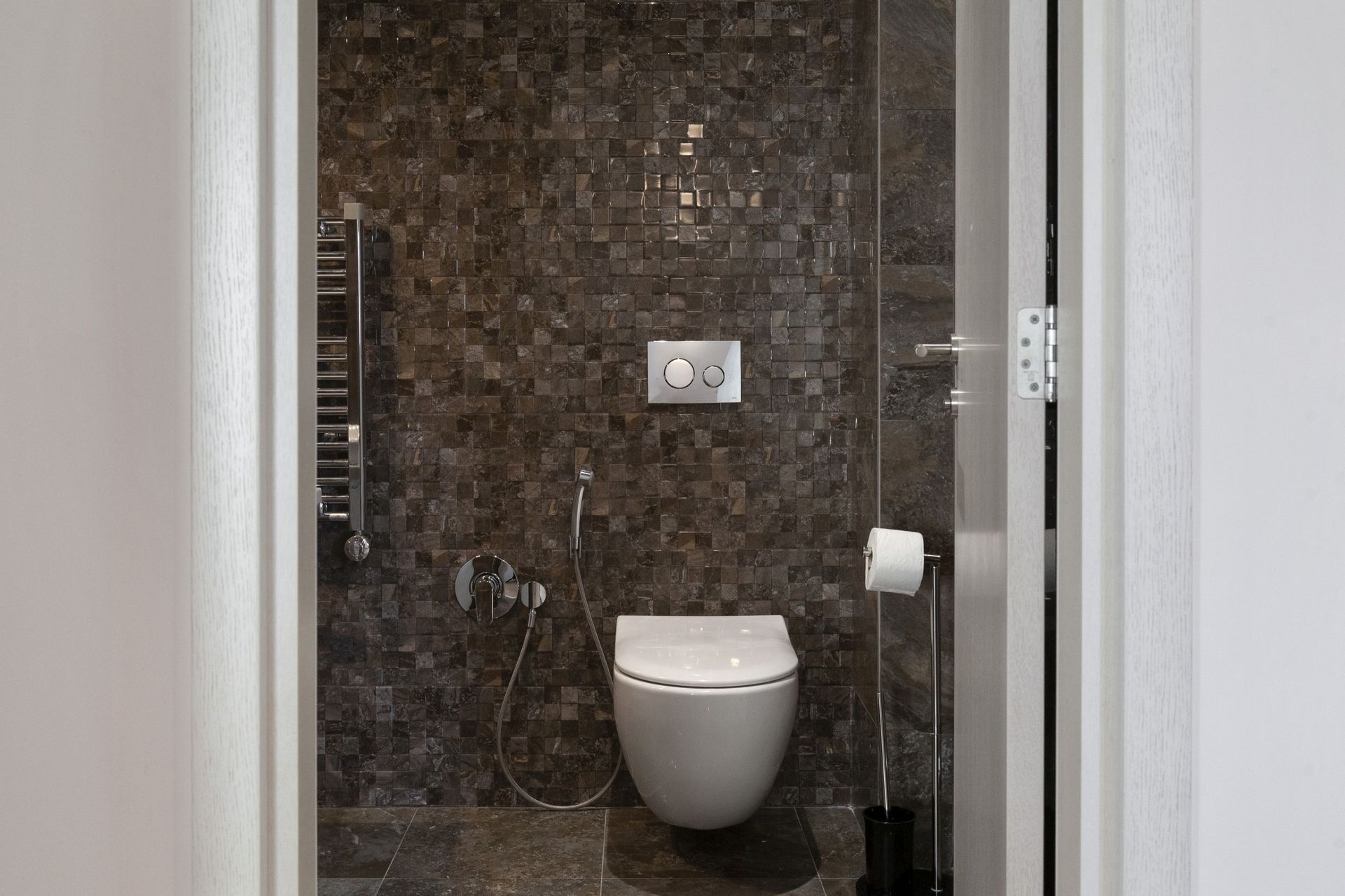 Modern bathroom in an apartment in Kotor, Montenegro: wall-mounted toilet, bidet shower, and mosaic tile.