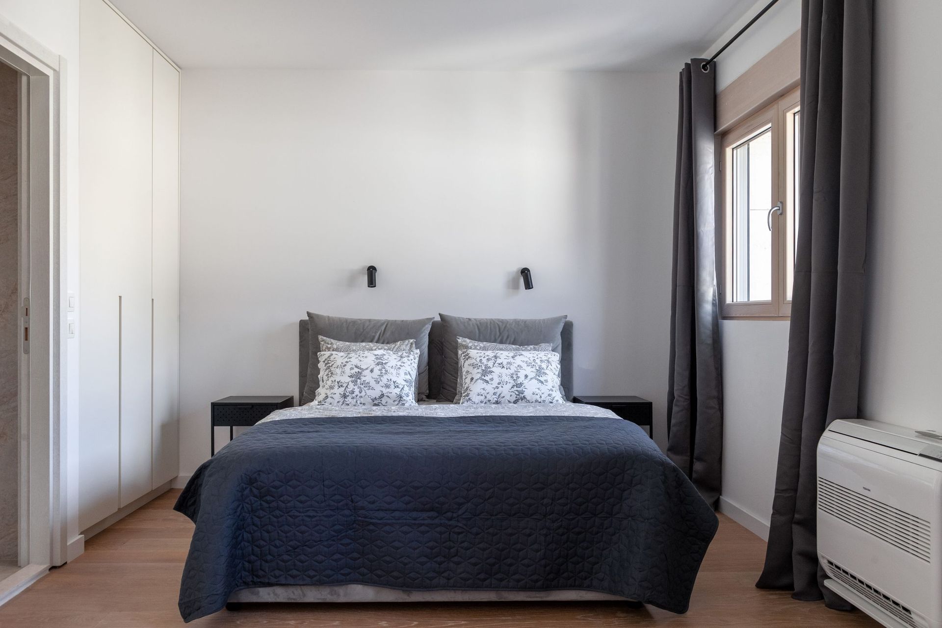 Modern bedroom with a double bed and built-in wardrobe in an apartment in Kotor, Montenegro.