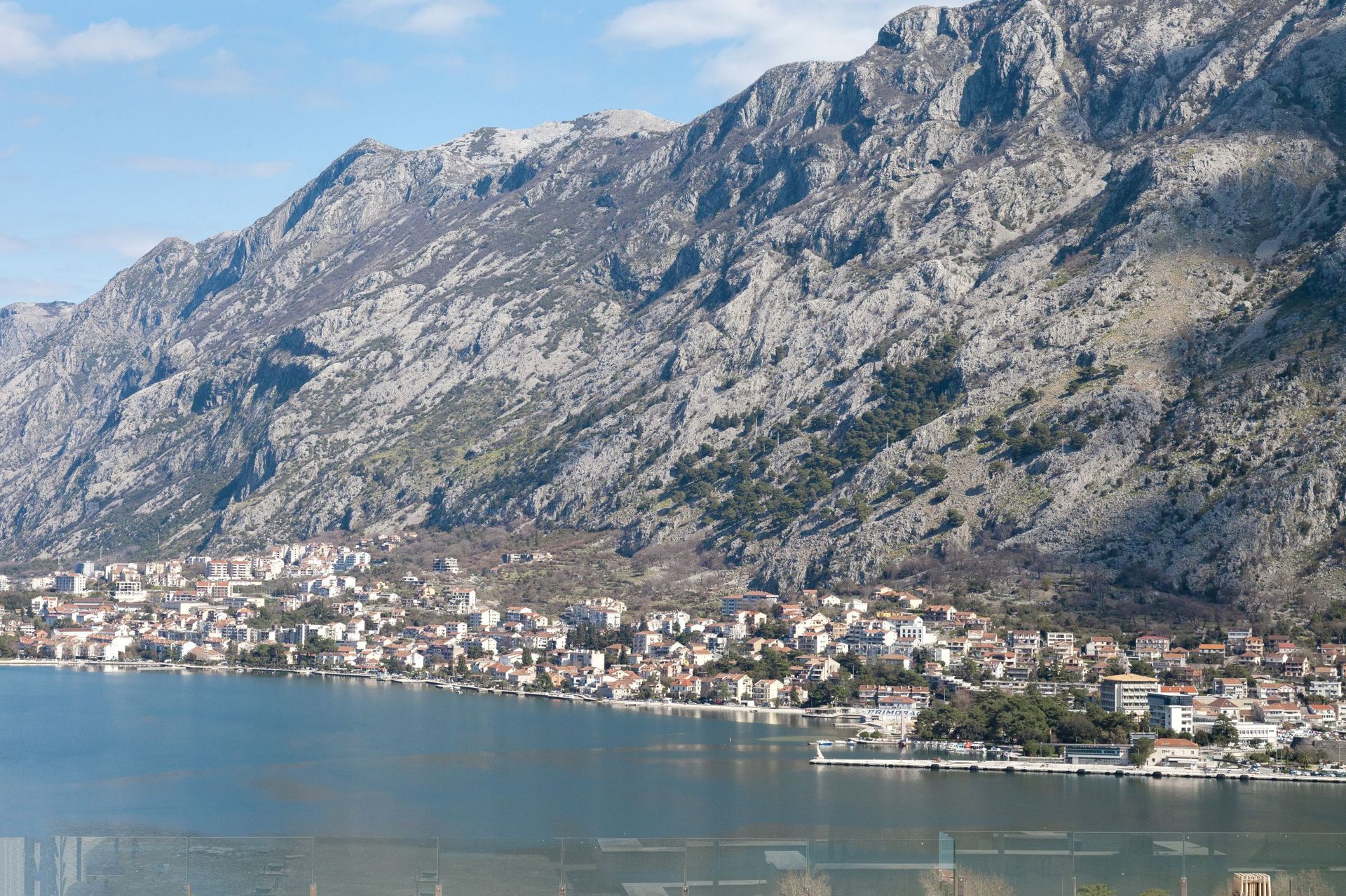 Panoramic view of Kotor Bay and the mountains from the apartment window in Kotor, Montenegro: a coastal town and seascape.