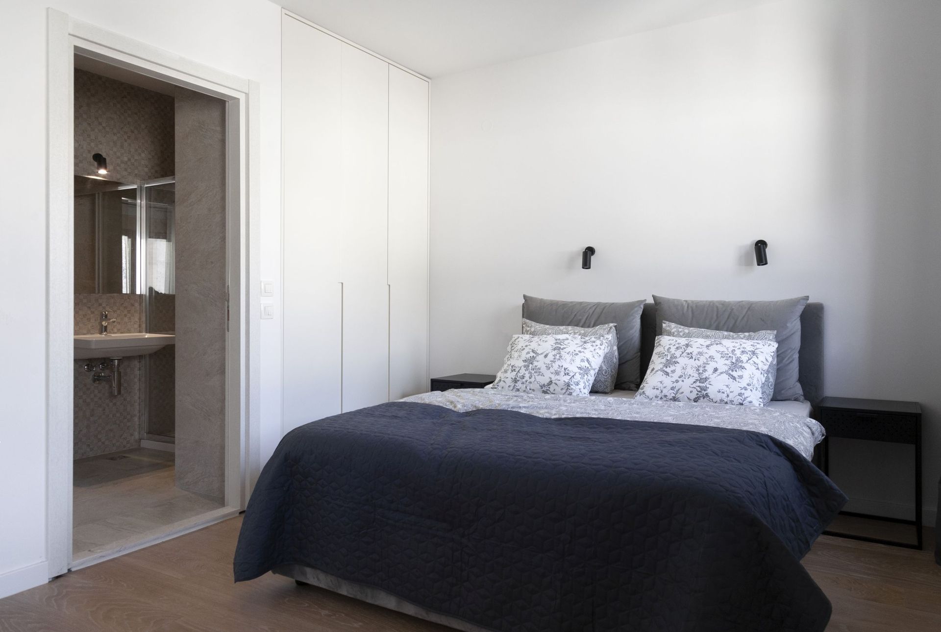 Modern bedroom with a double bed and en-suite bathroom in an apartment for sale, Kotor, Montenegro.