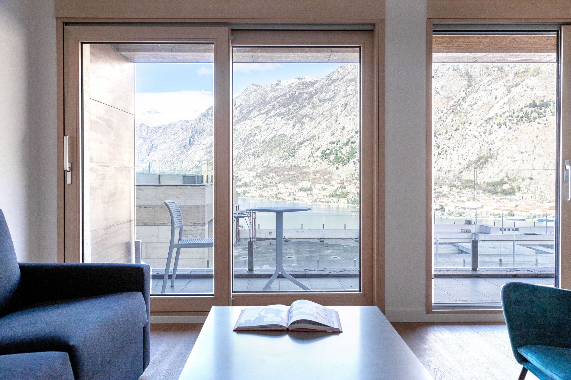 Living room with panoramic views of Kotor Bay and the mountains, apartment in Kotor, Montenegro, modern interior with a terrace.