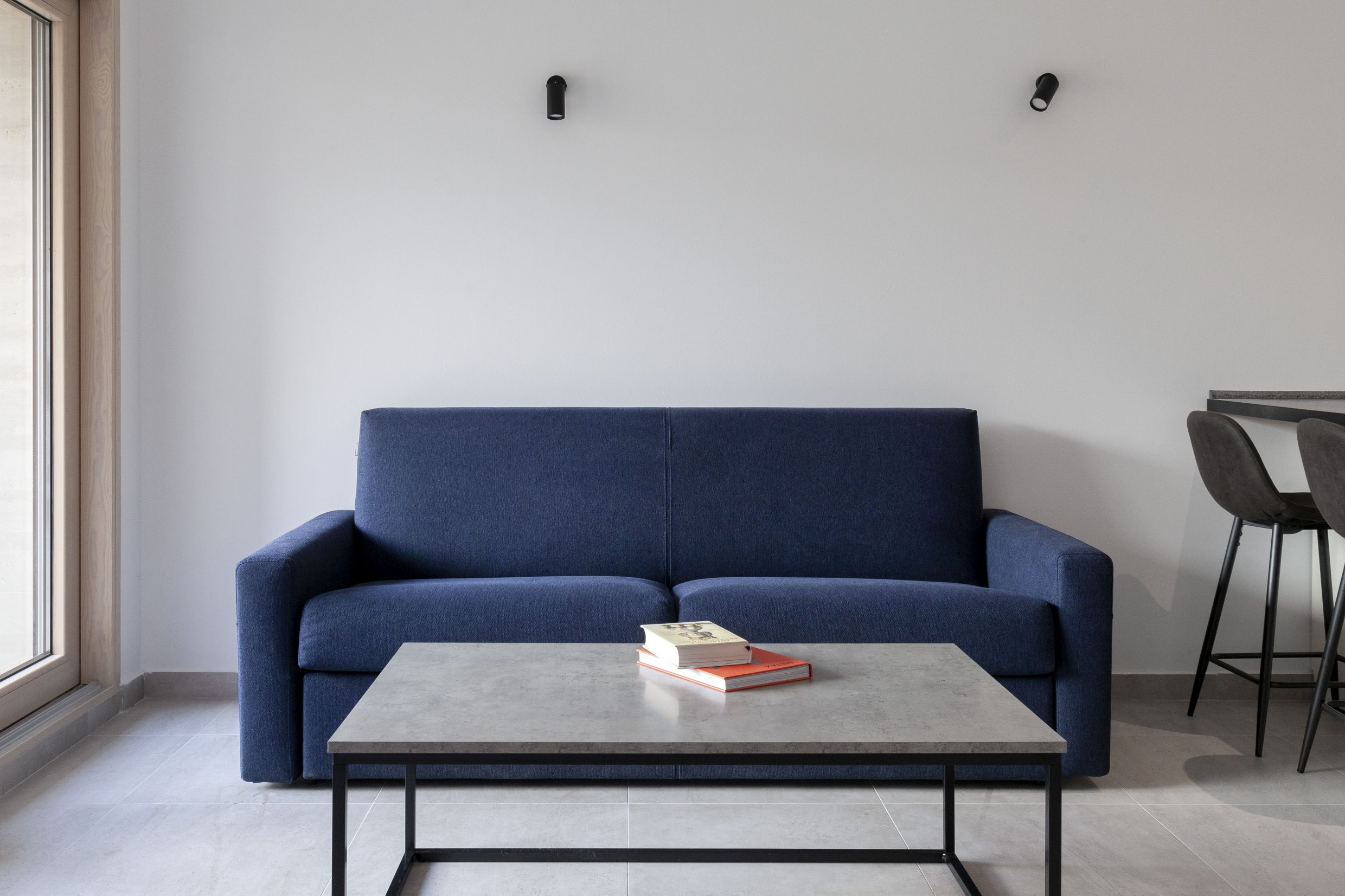 Modern living room with a blue sofa and coffee table in an apartment in Kotor, Montenegro.