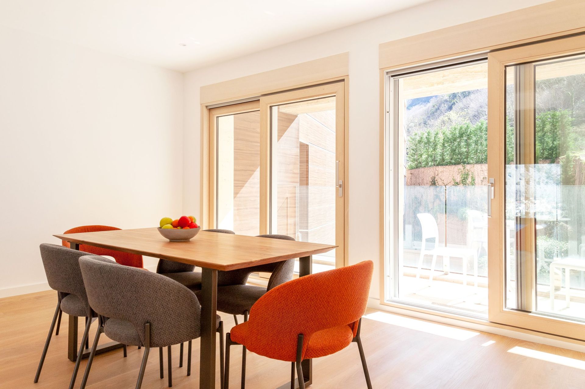 Modern living room with dining area and panoramic windows in an apartment in Kotor, Montenegro.