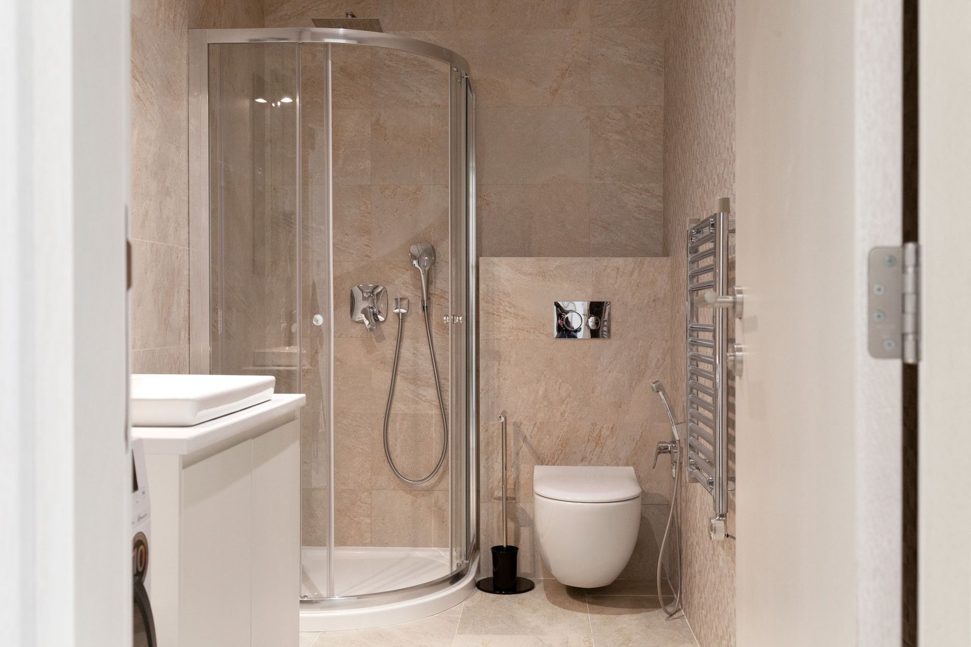 Modern bathroom with a shower cabin and wall-mounted toilet in an apartment, Kotor, Montenegro.